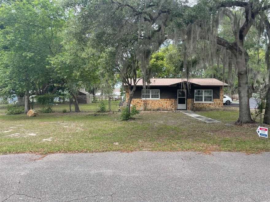 Great location in Polk City, walk to town,  corner double lot, no HOA, room for RV or boat, completely fenced, fresh paint, new master shower, blinds, paddle fans, tile floors, covered rear porch, 3 bedroom, 2 bath split plan, family room, separate living room, small eat in kitchen area, 
laminated flooring, indoor utility room with hood up for washer/dryer. Large lot 135 x 100, Flood zone X, covered porch, large storage shed,  Easy access to I-4. New Publix shopping center about 3.2 miles. Ride your bike 50 miles on the Van Fleet State Park Bike Trail to Auburndale or Clermont. Four point and wind available. Newer roof, new driveway, recent upgrades.