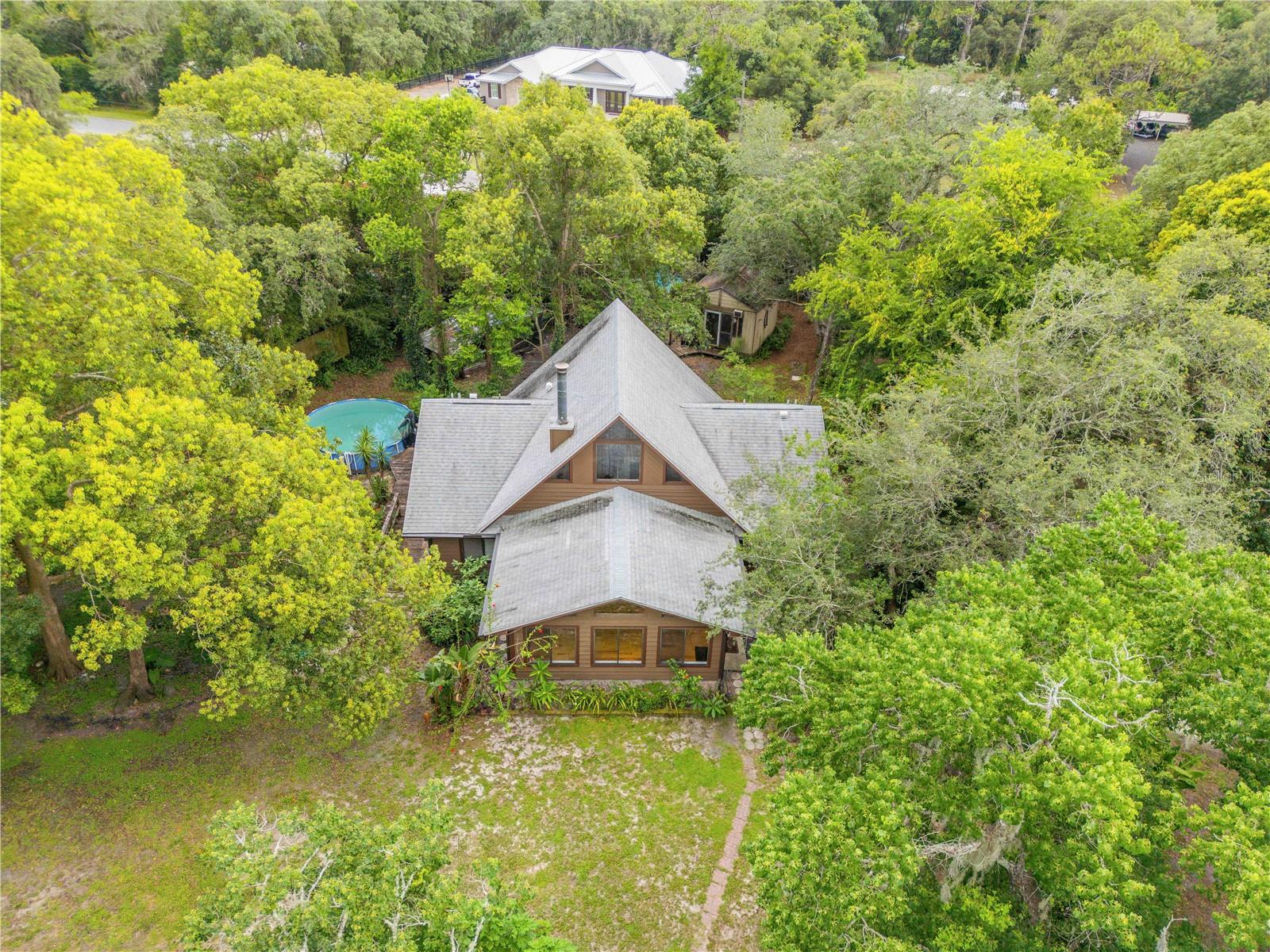 One or more photo(s) has been virtually staged. Seller to offer concessions of $5,000 to buyer for new appliances. Nature, Privacy & Adventure Await! Welcome to Wekiva River Acres, where peaceful living meets outdoor adventure! This charming Florida ranch-style home sits on over 1 acre of fully fenced land, complete with a barn, pasture, and native landscaping that offers exceptional privacy. A fruit lover's paradise, you'll love the mango, orange, guava, banana, pomegranate, persimmon, lemon and cherry trees, along with wild pineapples, and the overall natural beauty that surrounds you. Inside, enjoy a bright, open floor plan with panoramic windows, vaulted ceilings and a spiral staircase leading to a spacious loft — ideal for entertaining, relaxing, or working from home. The 2021 roof adds peace of mind, and the layout offers flexibility for a variety of lifestyles. This unique property is just minutes from Rock Springs Run State Reserve and Wekiva Falls Resort, where you can launch kayaks, canoes, and boats, enjoy picnics, or take advantage of the waterpark and other resort-style amenities. With easy access to SR-46, 417, I-4, and 429, commuting throughout Central Florida is a breeze. USDA loan eligible, with agricultural zoning and no HOA, it offers a great opportunity to own a private retreat just outside the city. Don’t miss your chance to live where others vacation!