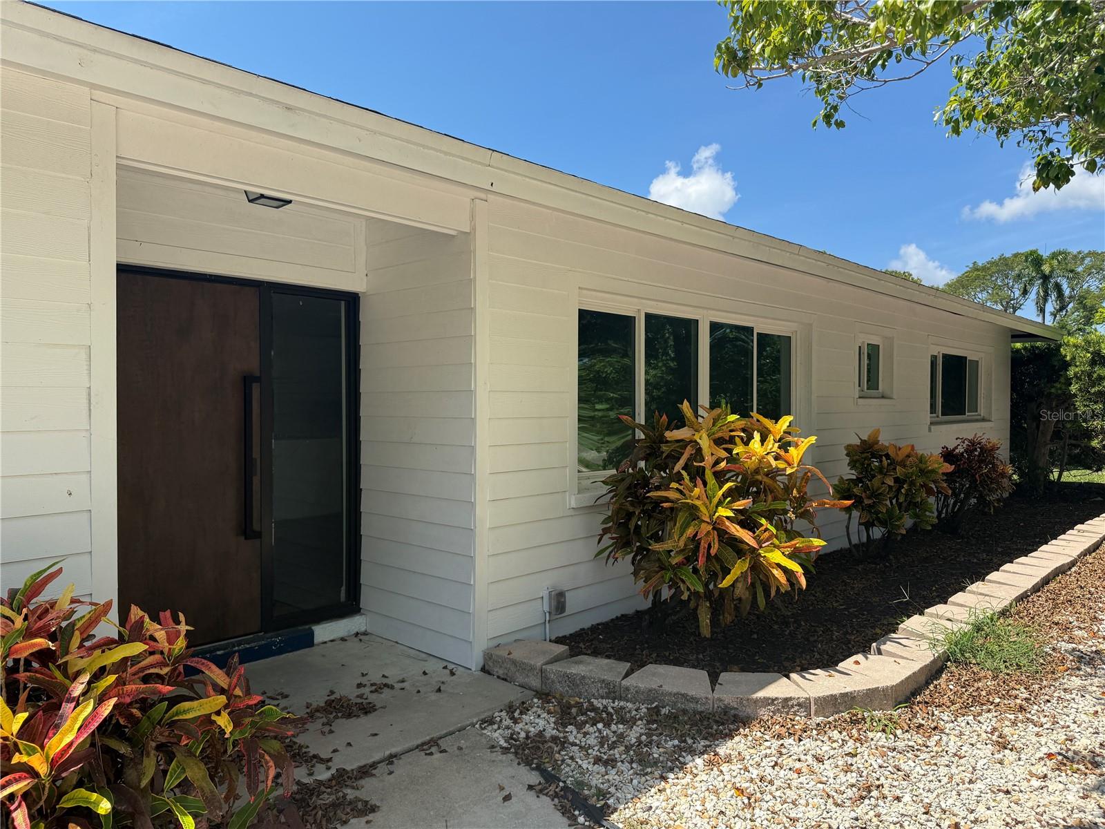 Ideal central 'West of the Trail' location with close proximity to New College & University of South Florida, Ringling Museum, University Town Center, downtown Sarasota, multiple beaches, and Sarasota International Airport. Upon entering, you will notice a delightful view of the Sarasota Bay down the road and will be greeted by modern interior finishes, as the property was recently updated - be the first to reside since the renovation! Open kitchen with oversized island for cooking and dining, formal living - dining combo in the front of the residence with separate large family room in the back, overlooking the backyard. Primary bedroom suite offers an adjacent seating area, den or office - perfect for serene moments or a secluded space to work with access to the screen patio lanai. Second bedroom suite offers a bathroom with tiled shower. Third bedroom offers bathroom ensuite, with shower stall, commode closet and private exterior access door. Powder room with commode available for guests adjacent to the formal living room. Available for residency - Early September. Lawn care available for additional fee.