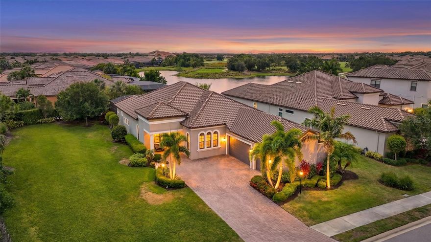 There’s a reason so many people dream about living in Esplanade Golf and Country Club at Lakewood Ranch. It’s not just the golf. It’s not just the resort amenities. It’s the way life feels here.

Maybe it starts with mornings spent walking to the clubhouse for coffee before a tee time. Maybe it’s afternoons at the Bahama Bar after a workout or a match of pickleball. Or maybe it’s coming home at the end of the day, opening the sliding glass doors, and watching the Florida sunset stretch across the pool, lake, and fairway beyond.

At 4828 Benito Court, that lifestyle becomes your everyday reality.

Built on a premium golf deeded homesite overlooking the 18th tee box, this residence was designed for the buyer who wants luxury without sacrificing comfort. The Luca floorplan offers over 3 bedrooms with a flexible office or bonus room that can easily serve as a 4th bedroom, all paired with 3 full bathrooms, a powder bath, and living spaces that feel open, warm, and connected from the moment you walk inside.

Natural light pours through transom windows and walls of sliding glass doors, highlighting the soaring ceilings, crown molding, custom trim work, and travertine flooring throughout the main living areas. Every room feels intentional. Elegant without feeling formal. Spacious without feeling overwhelming.

The kitchen was designed to be lived in. A massive floating island anchors the space with extensive cabinetry, granite countertops, double wall ovens, gas cooktop, wine cooler, walk in pantry, and thoughtful finishes throughout. Whether hosting holidays with family or opening a bottle of wine with friends after a day on the course, this is the kind of space people naturally gather around.

The outdoor living area feels like a private extension of the home itself. Covered lounge areas, a heated pool, expansive paver lanai, lush landscaping, and views across the water and golf course create an atmosphere that feels more like a luxury resort than a backyard. With no neighboring home immediately beside the property and plumbing already in place for a future outdoor kitchen, the space offers both privacy and potential.

The primary suite was designed as its own retreat, complete with a spacious sitting area, oversized walk in closet, and a spa inspired bathroom featuring dual vanities, extensive storage, and a large walk in shower finished floor to ceiling in tile. Each guest suite offers privacy and comfort with en suite bathrooms, making the home equally functional for full time living or hosting visitors escaping the northern winters.

Additional features include impact rated windows and doors, remote controlled blinds, tankless water heater, built in office cabinetry, dedicated laundry room with storage and utility sink, and an epoxy finished three car side load garage.

Located within one of the most sought after gated golf communities in Lakewood Ranch, residents of Esplanade enjoy championship golf, resort pools, tennis, pickleball, fitness facilities, spa services, dining, social events, and a lifestyle centered around connection and convenience. Just minutes from Waterside Place, UTC shopping and dining, Lakewood Ranch Main Street, Sarasota Polo Club, MOTE Marine Aquarium, and some of the best beaches in Sarasota, this home places you in the center of everything that has made Lakewood Ranch one of the fastest growing and most desirable communities in Florida.