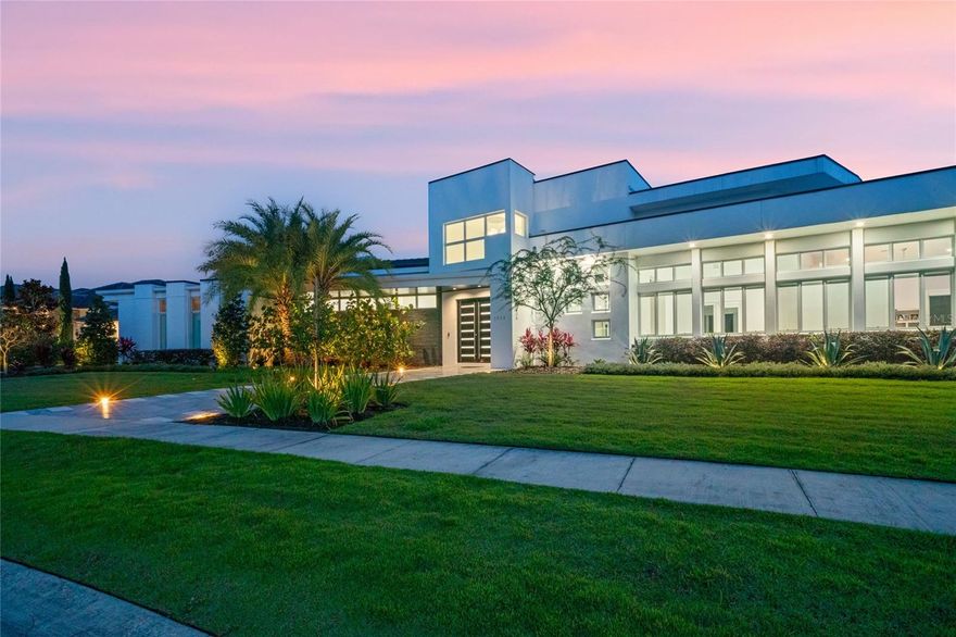 Welcome to your MODERN CUSTOM HOME in the exclusive Sawyer Sound neighborhood! This rare single-story Cam Bradford masterpiece boasts an expansive open floor plan. Designed with family and entertainment at its core, the home is bathed in natural light, thanks to stackable sliding doors that merge the indoors with a serene pool area.

For the culinary enthusiast, the CHEF'S DREAM KITCHEN awaits. Adorned with natural stone quartzite countertops, high gloss Boca Acrylic cabinets, and a Thermador PROFESSIONAL SERIES range, hood, and double oven, every meal becomes a celebration. The kitchen also features a concealed walk-in pantry and refrigerator drawers in the island, ensuring snacks and drinks are within everyone's easy reach. Start your mornings with the Brew Express built-in coffee maker, conveniently located opposite the Thermador Microdrawer.

Elevate your hosting game with the IMPRESSIVE CUSTOM BAR. Highlighted by a backlit onyx wall and underbar, it comes equipped with a built-in ice maker and double wine refrigerator.

The SPACIOUS OWNER'S SUITE is a haven of luxury, complete with two walk-in closets and an en suite bathroom showcasing a herringbone marble tile shower. Adjacent to the suite is a well-appointed home office with high gloss cabinetry. The home also offers an additional living space, perfect as a playroom or teen lounge, equipped with a dry bar and refrigerator drawers. Three more bedrooms come with ENSUITE PRIVATE BATHROOMS. Need more space? The MOTHER-IN-LAW SUITE, currently a second office, offers pool views and can easily serve as a 5th bedroom.

The air-conditioned 3-car garage houses an electrical room for the home's video surveillance system. A vast laundry room accommodates two washer-dryer sets and offers ample storage.

The outdoor area is a true showstopper. Retractable screens, a state-of-the-art outdoor kitchen, a fire-pit, and a saltwater pool with DANCING WATER JETS promise endless fun. As night falls, built-in LED lighting accentuates the home's elegance.

Nestled in a gated enclave of around 20 private estates, Sawyer Sound promises exclusivity. Located in the esteemed Windemere School district, it's a stone's throw from Disney World (6 miles) and Universal Studios (11 miles).

Experience luxury like never before in this exquisite custom home. Your journey of opulence awaits! Room Feature: Linen Closet In Bath (Primary Bedroom).