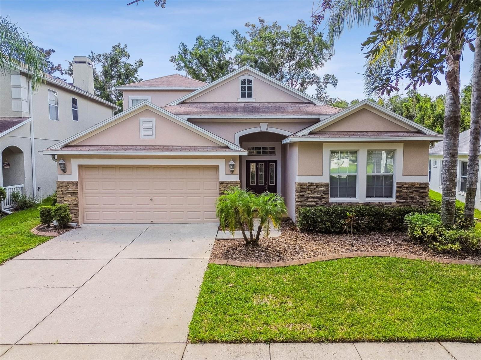 One or more photo(s) has been virtually staged. Welcome to 18434 Red Willow Way, located in the highly sought-after Asbel Creek community, where you’ll enjoy NO CDD FEES AND LOW HOA DUES. SELLER WILL INSTALL A NEW ARCHITECTURAL STYLE ROOF WITH ACCEPTED OFFER!! This beautifully maintained home offers just under 2,600 square feet of living space, 3 spacious bedrooms, and a versatile upstairs bonus room, all situated on a private lot with WOODED CONSERVATION VIEWS and NO REAR NEIGHBORS. Step inside and you’ll immediately notice the tall ceilings and gleaming engineered wood floors that run throughout the downstairs living areas. All windows and sliders have custom draperies throughout for an added personal touch. Crown molding highlights the main living spaces, while the master suite boasts a stunning double tray ceiling with crown molding for an added touch of elegance. The master bedroom also includes a large walk-in closet, while the master bathroom is outfitted with a huge marble-topped double vanity, a soaking tub, and a tiled walk-in shower. The two guest bedrooms are generous in size and located at the front of the home away from the master bedroom for added privacy. They share a well-appointed bathroom with a granite-topped vanity and a tiled tub/shower combination. The kitchen is a true centerpiece, featuring 42-inch wood cabinetry with crown molding, granite countertops, an island with extra storage, stainless steel appliances including a French door refrigerator, and a cozy breakfast nook with a large window seat. Just off the kitchen, the laundry room comes equipped with a top-of-the-line washer and dryer plus extra cabinetry for storage. The dining and great rooms are generously sized, filled with natural light, and open directly to a large, screened patio overlooking the wooded conservation area, perfect for entertaining or simply relaxing at home. Upstairs, the oversized bonus room provides endless options as a media room, game room, home office, or even a bedroom with a sitting area. Additional highlights include an epoxy-coated garage floor, custom window treatments, soft neutral paint tones, and a home that has been very gently lived in. Asbel Creek offers an ideal balance of convenience and serenity, all just minutes from Angeline Sports Complex and Academy of Innovation, Lake Rogers Park, the Veterans Expressway, the Suncoast Trail, golf courses, restaurants, and premier shopping. Best of all, this home is not in a flood zone. Don’t miss your chance to own this extraordinary property in one of the area’s most desirable communities. Call today to schedule your private showing!