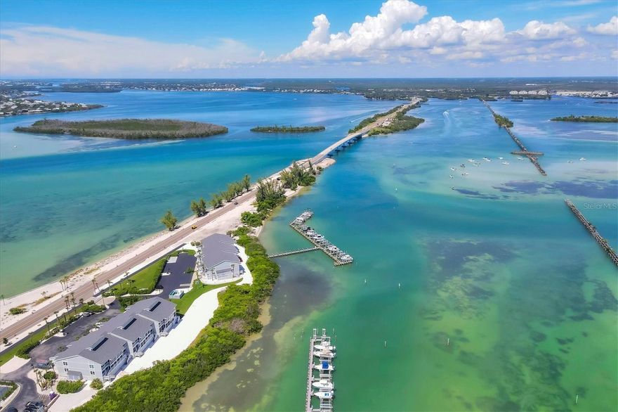 Amazing waterfront retreat with both Gulf & Bay views!  Located in Boca Grande North- Unit A2 is nestled on Gasparilla Island near the picturesque Village of Boca Grande, Florida. This 2-bedroom, 2-bathroom bayfront seaside condo is turnkey furnished and offers a perfect blend of luxury, comfort, and breathtaking views, making it an ideal haven for those seeking the coastal lifestyle.  
One of the standout features of this condominium is the balconies - allowing gulf views & the large screened lanai overlooking the Gasparilla Sound, where you can see the boats, kayaks, dolphins, and more cruising by, but still enjoy your privacy. You can savor your morning coffee while watching the sunrise over the water or unwind in the evening with a glass of wine as the sun sets. The panoramic views are simply unparalleled.  Have a boat? Private Boat Slips can be rented separately or are often available for private sale.  Have furry friends?  You will enjoy this pet friendly community. Owners can have two dogs and there are great walking paths!

This beautifully appointed turnkey furnished 1,248-square-foot home greets you with an open and airy floor plan that seamlessly connects the living, dining, and kitchen areas. The spacious living room floods the space with natural light from impact glass windows & doors and provides nearly unobstructed views of the surrounding waterways of the Gulf of America & Gasparilla Sound. This allows you both sunrise & sunset from either of the porch areas.  Imagine relaxing here after a day on the water, soaking in the serene ambiance. Coastal elegance abounds in the finishes, beautiful artwork and accents and yet allows for a comfortable entertaining space.  

The modern kitchen boasts high-end appliances, ample cabinetry, and a convenient breakfast bar for casual dining. Whether you're preparing a gourmet meal or a quick snack, this kitchen caters to all your culinary needs.  The dining area has amazing views and can seat up to six.

The master suite is a true sanctuary, complete with a generous closet and an en-suite bathroom featuring elegant fixtures and finishes.  The impact-resistant glass sliders allow you to enjoy wide-open views of the water as you relax in bed.
The second bedroom is equally inviting with impact glass sliders leading to the porch allowing direct views to the Gulf.

Residents of this gated community have access to a range of amenities, including a sparkling heated swimming pool & spa, well-maintained grounds, tennis/pickleball courts, a clubhouse, a gulf-front area, golf cart charging and convenient access to boating facilities. Additionally, the property is located just a short distance from the charming shops, restaurants, and pristine beaches of Boca Grande, ensuring you're never far from leisure and entertainment options.  Golf carts are welcome and have a nearby path to lead you to the Village.
Let's not forget the world-class pristine beaches, boating and fishing.

This unit has a wonderful rental history - Whether you're seeking a full-time residence, a vacation getaway, or an investment property this unit offers an exceptional opportunity to experience the best of Florida's Gulf Coast living. Current rental income and is ready for rentals or your home away from home.  Don't miss your chance to own a piece of paradise in this sought-after location. Schedule your private showing today and prepare to be captivated by all this remarkable property has to offer.