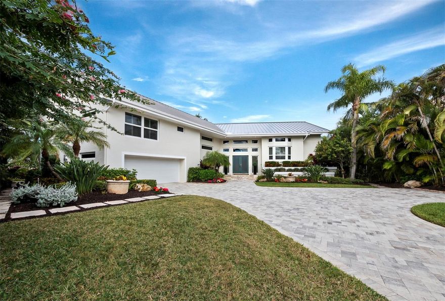 Behold the pinnacle of opulence and waterfront splendor within the coveted Bay Isles community – an extraordinary sanctuary nestled in The Bayou. This meticulously crafted 3B +Study/4.5BA, 3,687+/- sq. ft., 2-story residence offers an unparalleled waterfront experience with 217’ of private water frontage, a rare find in The Bayou. As you follow the lushly landscaped, stepped paver walkway, the foyer welcomes you with volume, style and character, setting the tone for the exceptional residence that lies beyond. Enter into a space defined by high ceilings, marble tile floors and a thoughtfully designed floor plan. The primary suite is positioned on one side and ensures privacy with a study/office, 2 walk-in closets and 2 complete baths, while the guest bedrooms on the opposite end offer comfort and convenience. Transom windows in the living area invite natural light, creating an airy and inviting ambiance throughout. The fully equipped bar setup enhances the entertainment potential of the living space, providing the perfect setting for hosting guests. The spacious kitchen is a delight, featuring all-white cabinetry, stainless steel appliances, beautiful lighting treatments and gas line available at your preference. Adjacent to the kitchen is a welcoming dining area, creating a seamless flow for both everyday living and special occasions. Step out onto the expansive wraparound balcony to enjoy panoramic views of the tranquil lagoon and Cranes Bayou, or retreat to the private open pool surrounded by a large pool deck and enveloped by tropical landscaping. The golfer will absolutely love the well-manicured putting green right by the water, while boating enthusiasts will appreciate the easy access to the Sarasota Bay, complemented by a kayak lift that can be converted into a boat lift. With a high impact glass, good elevation and a new 2023 metal roof, this waterfront haven is designed for those who seek the very best. Residents of The Bayou have access to all the amenities of Bay Isles and its fabulous beach club. Longboat Key Golf & Tennis Country Club membership and Harbourside Moorings deepwater slips are available.