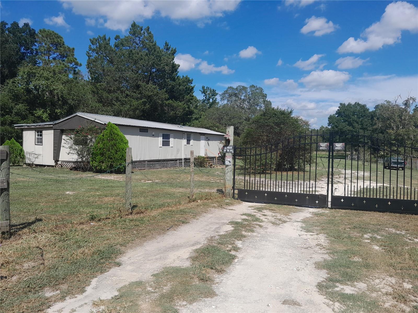15.67 ACRE FARM WITH GREAT PASTURES! One paddock with 3 board fencing and the entire property is wire perimeter fenced. Livestock is chickens, ducks, peacocks, hogs...goats, horses, cows....whatever you would like for your farm. Owners will take their animals with them. There is a 2 bedroom, 2 bath remodeled Single-Wide mobile home with new kitchen cabinets and counter tops. Fresh paint and new electric. 5 year old metal roof. Laminate flooring throughout. It does not have A/C. New front steps. Well was replaced in July 2025. 2 septic systems - one for the mobile and one for the accessory dwelling home that has 2 lofts, 1 bedroom and 1 bathroom. Perfect for a mother in law suite, guest house or a farm hand. Duke Energy provides electric service to the property, high speed internet is via Central Florida Broadband and Verizon has cell service in the area. Behind the home is a carport which houses the dryer and washer and also has an RV hook up, and the well is behind it. Large 17' x 36' center-aisle barn with 3 stalls and a tack room. LOCATED NEAR Black Prong, Goethe State Forest, WEC (World Equestrian Center) in Ocala as well as HITS (Horses IN The Sun) near Williston, FL. Within 30 minutes to Ocala, Williston and Gainesville. High and Dry, No HOA and No Flood Zone. Call for your appointment today!!! All measurements are approximate. Please do your own do diligence.