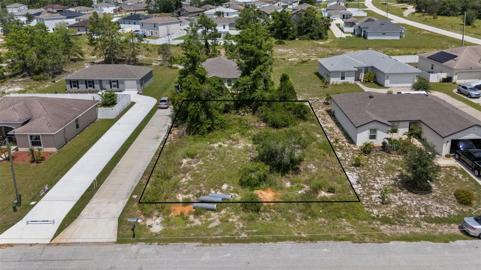 The seller owns 12 lots in Poinciana, several on the same street, which can be PURCHASED IN BULK, presenting a rare opportunity for builders or investors to secure multiple parcels at once at a discounted rate. MLS Numbers: O6335500, O6335683, O6335685, O6335689, O6335698, O6335703, O6335716, O6335719, O6335726, O6335730, O6335755. With only a few large trees, this lot at 309 Elderberry is ready for your next project. The low HOA fee includes access to the Poinciana Victory Pool, Aquatic Center with 8 lap lanes, and the APV Community Center featuring event rooms, an amphitheater, a fitness center, and expansive outdoor recreation with sports fields, basketball courts, playgrounds, picnic areas, and walking trails. High-speed internet (300 Mbps) and cable TV (250+ channels) are also included. The lot is conveniently located near shopping centers and restaurants. It’s a short drive to Disney, SeaWorld, Universal Studios, Legoland, and Orlando International Airport, offering both lifestyle and convenience. This lot is perfect for new construction or long-term investment. With low HOA fees, abundant amenities, and strong area growth, these Poinciana lots provide unmatched opportunity for builders, investors, or future homeowners.