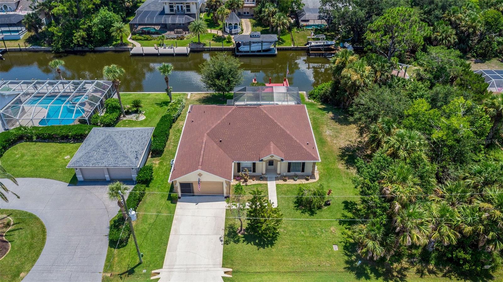 **Discover Your Ideal Waterfront Lifestyle! Just 15 Minutes to Flagler Beach!** Prepare to be amazed by this remarkable waterfront treasure, where endless opportunities meet luxurious coastal living**! Nestled in the sought-after C-section, this **concrete block home provides everything you've been looking for— this **3-bedroom, 2-bathroom** beauty spanning over 1900 sq ft of living space** is perfect for those who desire it all—**generous living areas, breathtaking views, and a life of ultimate relaxation** in a peaceful Cul-de-Sac.
As you step inside, you'll be greeted by a spacious family room ideal for unwinding or hosting lively gatherings. The **expansive living room** is an entertainer's paradise, seamlessly connecting to the kitchen and offering an abundance of space for family fun, celebrations, or simply enjoying the luxury of having room to breathe. Picture yourself cooking in a **bright, open kitchen** with **panoramic water views** and a **sparkling blue pool** as your backdrop—it's the perfect setting for meal preparation while basking in the natural beauty of your surroundings. The master suite serves as a private sanctuary, featuring 2 walk in closets for him and her. The **oversized space in the owner's bathroom is ready for you to create your **personal spa oasis**—a serene space to relax and rejuvenate after a long day. For those who value space and practicality, the oversized laundry room offers ample storage! When you step outside, prepare to be awestruck! The vast pool deck** is the perfect venue for entertaining, sunbathing, or hosting unforgettable pool parties. The 36x31 foot pool deck** is your own private paradise**—ideal for cooling off, leisurely floating on a sunny afternoon, or enjoying year-round swimming in Florida's warm climate. But there’s more**—your **private dock provides direct water access, allowing you to fully embrace the waterfront lifestyle. Envision yourself **watching dolphins swim, **casting a line for dinner**, or simply relaxing by the water, soaking in the stunning views and sounds of nature. Whether you're dining at a local beachside restaurant or lounging on the shore, the best of coastal living is right at your fingertips. With a **new roof (2023)** and **new AC unit (2022)**, New paint, New luxury vinyl flooring and more! You can move in with confidence and start enjoying your salt life right away. This home is not merely a place to live—it's a lifestyle, an experience, and a dream fulfilled. Don’t let this chance pass you by—**schedule your private showing today and claim this **waterfront haven** as your own!