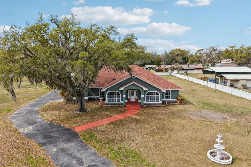 Welcome to 7026 Pinehaven Drive, a country estate tucked away at the end of a quiet cul-de-sac in Lakeland. This fully gated sanctuary is enclosed by a permanent cement block wall and ornate iron gate, offering the ultimate in privacy and "Unincorporated Freedom" with no HOA restrictions for your RVs, boats, or trailers.  Inside the 4,264-square-foot residence, you’ll find an artisan chef’s kitchen featuring a $6,000 Verona Italian stove, custom-carved hood, Carrara marble countertops, and an antique-base butcher block island, all flanked by an enormous 12-foot by 7-foot walk-in pantry. Even a game room with a pool table included! The versatile floor plan is divided into a 3-bedroom/2-bathroom main home and a private 3-bedroom/1-bathroom guest wing with its own wet bar and garage, perfect for multi-generational living. Every detail has been curated for "no-stress" living, including a brand-new roof (2023), updated HVAC (2021/2025), and freshly maintained brand-new well tank(2025) and septic systems (2025). From the hand-laid mosaic tile flooring to the master suite’s standalone soaking tub with pebble-stone accents, this estate seamlessly blends high-end Italian craftsmanship with serious industrial utility. The property’s standout feature is a massive 2304 ft.² pole barn with four oversized car stalls and one climate-controlled area, making it a dream for collectors, hobbyists, or home-business owners. Schedule a private showing today!