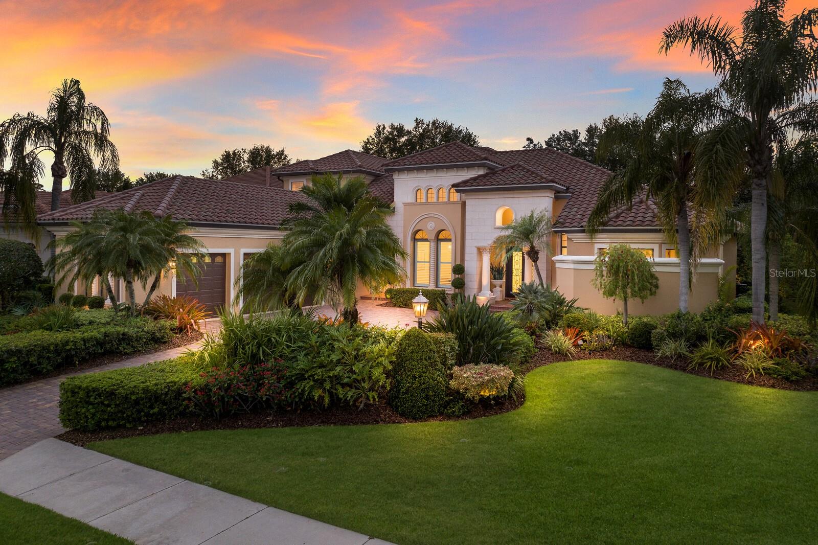 The ultimate tropical oasis setting, this elegantly appointed two-story residence in Lakewood Ranch Country Club exudes a swoon-worthy and private resort feel . The expanded Ballina by John Cannon Homes encompasses 4,487 square feet of generously proportioned living spaces, soaring ceilings, architectural detailing, and an an expansive outdoor retreat with extensive open and under cover spaces, full summer kitchen with new 2024 grill, and heated pool/spa. Live and entertain flawlessly in this two-story that has been impeccably maintained and updated throughout exuding a classic elegance where there is no shortage of living well.
Beyond the hurricane impact iron entry doors reveals the grandly-sized living room with floor-to-ceiling aquarium windows just off the formal dining area juxtapose a wet bar with new thermostat controlled GE Monogram wine refrigerator, sink, stone counters and wood cabinetry. Meanwhile the epicenter of the home is the family gathering room boasting a gas fireplace and disappearing cornerless sliding glass walls that brings the outdoor living area in seamlessly incorporating the breakfast area and gourmand’s well-appointed kitchen with ALL NEW 2024 GE Monogram appliances, wood cabinetry, ample granite and quartz counters, and an oversized walk-in pantry. The residence also features a designated office on the main level that offers built-in bookshelves, soaring ceilings and wood flooring.
Relax and unwind in the elegant owner’s retreat positioned on its own private wing on the main level with direct lanai access, elevated sitting area, two customized walk-in closets, and a luxuriously appointed spa-like bath with separate vanity stations, dual entry shower, and a separate soaking tub. Guests will appreciate two generous suites on the main level, each with access to their own full bath and walk-in closets. The home’s fourth guest suite and fourth full bath resides on the upper level, as does the expansive bonus room with screened terrace offering flexible living options as a theater, game room, secondary office or potential 5th guest suite.
Positioned within the luxury enclave of Legends Walk, there are numerous appointments that highlight this magnificent Country Club residence, some of which include newly installed AC units in 2021, impact double iron front doors in 2022, hot water heater in 2021, new pool heater in 2023, Sonos sound system inside and outside updated in 2022, landscape lighting updated in 2021, refurbished sprinkler system in 2022, laundry room with ample cabinetry, sink and newer washer/dryer, interior paint completed in 2024, exterior painted in 2021, and a courtyard side-load 3 car garage with Garage Tek storage cabinets, and painted flooring in 2024.
Non-mandatory membership opportunities to become a member of Lakewood Ranch Golf & Country Club are possible, which includes a state-of-the-art Fitness center, Clubhouses, junior Olympic-sized pool, four 18-hole championship golf courses, Tennis, Pickleball and more. Lakewood Ranch is the #1 top-selling master-planned community in the country with shopping, dining, A-rated schools, and, of course, Sarasota’s renowned beaches.
