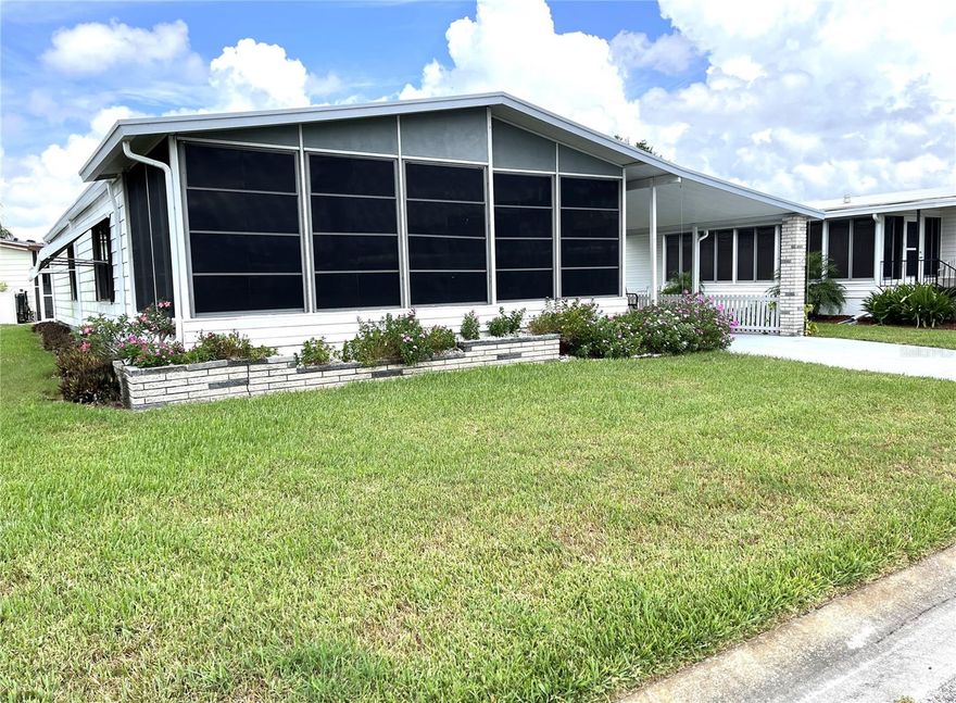 Nice 2 bedroom, 2 bath home in the popular 55+ community of Harbor Isles.  Own your land, bring your pets and enjoy the myriad of activities and amenities year round.  The marina is first come, first serve with docks, boat launch, kayak/canoe launch, fishing station and pavilion.  Lovely elevated front porch is enclosed and great for people watching while enjoying your morning coffee or afternoon libation!  Large galley kitchen is light & bright with plenty of counter space and storage.  The living room is spacious and open to the dining room, both with plantation shutters.  The primary en-suite will accommodate a king size bed and has a good size closet.  Bedroom 2 is conveniently located just steps away from the guest bathroom.  There is a screened lanai in the carport with direct access to the exterior utility room.  This home is ready to go and is ready for a new owner and their personal touches.  Walking distance to the recreation area.  Convenient to shopping, dining, entertainment, Braves ball field, downtown Wellen Park, beaches, interstate, airports and more.  Call today for your personal tour!
