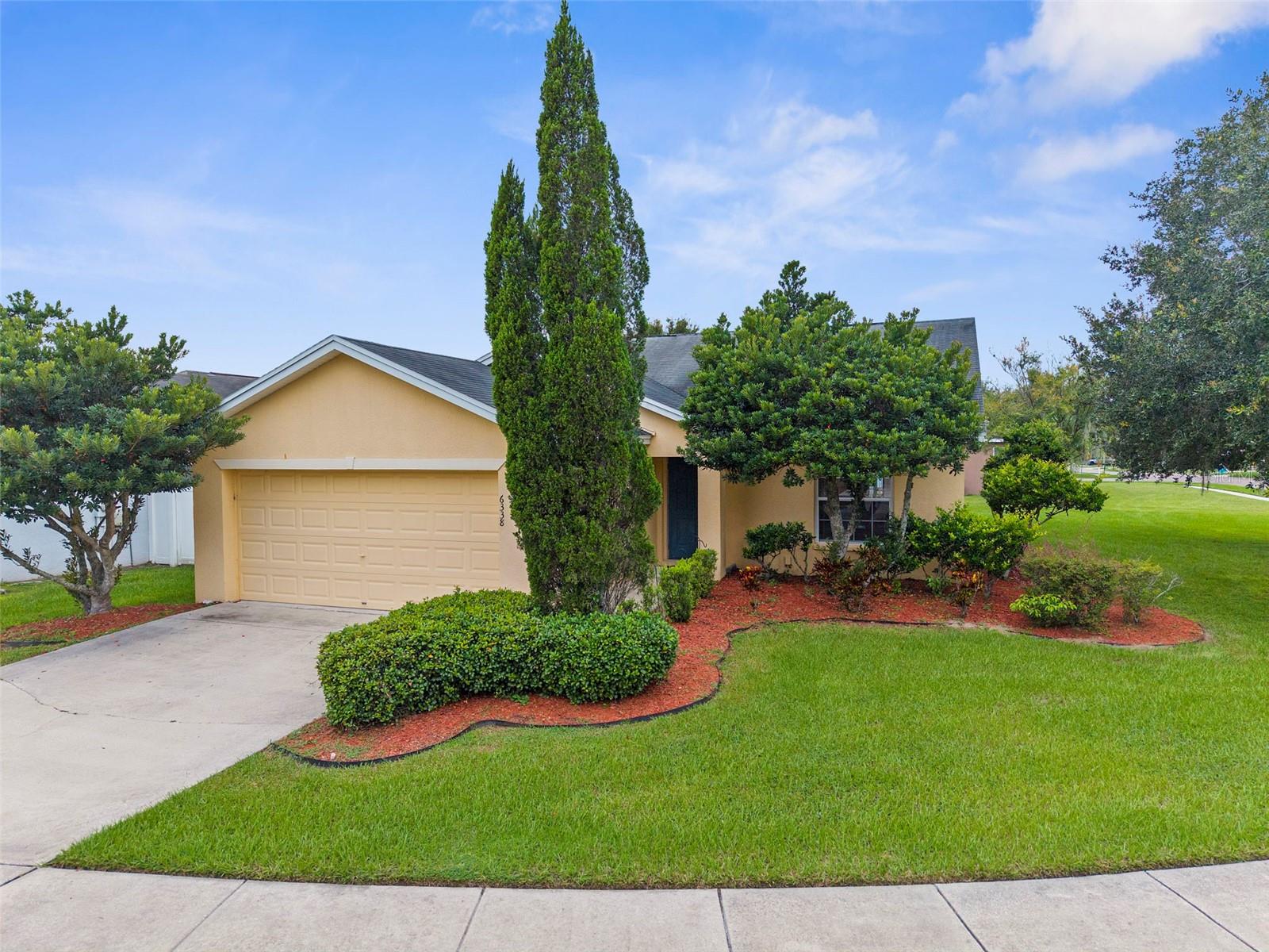 Beautiful CORNER LOT located in the desirable Greens at Hidden Creek community of Zephyrhills! This charming single-family residence offers a blend of comfort, functionality, and convenience, making it a perfect fit for first-time buyers, families, or anyone looking to enjoy Florida living at its best! Step inside to discover an inviting open floor plan with plenty of natural light, creating a warm and welcoming atmosphere. The spacious living area flows seamlessly into the kitchen and dining spaces, providing the perfect layout for both entertaining and everyday living. The primary suite offers a peaceful retreat with a private bathroom, while the additional bedrooms provide flexibility for family, guests, or a home office. Outside, you’ll find a well-maintained lot with attractive landscaping and a fenced backyard, ideal for outdoor gatherings, pets, or gardening! The two-car garage and wide driveway provide ample parking and storage space. Greens at Hidden Creek is a vibrant community with low HOA fees and no CDD, offering a peaceful neighborhood with a dog park and playground. Easy access to shopping, dining, schools, and medical facilities. You’ll love being just minutes from The Shops at Wiregrass, AdventHealth Center Ice, local golf courses, and charming downtown Zephyrhills. With quick access to major highways, commuting to Wesley Chapel, Tampa, or Orlando is a breeze. Don’t miss your opportunity to make this lovely home yours! Schedule your private showing today and experience all that this community has to offer!
