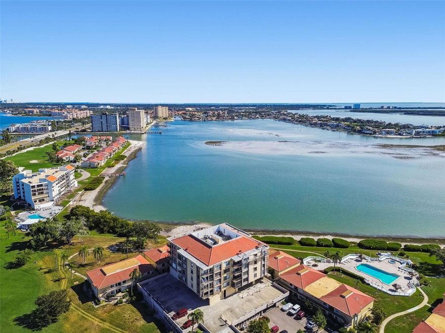 Bring All offers! Wake up to the serene beauty of Boca Ciega Bay in this bright and airy waterfront retreat. Positioned to capture peaceful water views and refreshing coastal breezes, this 2-bedroom, 2-bathroom condo offers the perfect canvas for your Florida lifestyle.  The interior has been thoughtfully refreshed with brand-new paint throughout, new carpeting in the living areas, and stylish luxury vinyl plank flooring in the dining room and primary suite. The kitchen is well-equipped with granite countertops and stainless steel appliances, while the versatile guest room features a space-saving Murphy bed and custom built-ins. This unit is minutes from the historic charm of Pass-A-Grille and the energy of downtown St. Pete.  Resort style amenities include a heated waterfront pool, fishing pier, kayak launch, bike storage, clubhouse with kitchen and billiards, covered garage parking, and plenty of guest parking. *Currently the exterior of the building is currently being renovated and waterproofed (standard maintenance). Any and all assessments have been paid in full.