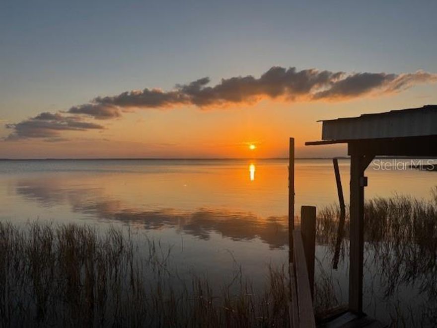 Lakefront Serenity with Sunset Views and Boating Access
Experience the tranquility of lakeside living on this picturesque 1/4-acre lot, perfectly positioned on the shores of Lake Eustis. Enjoy breathtaking sunsets and peaceful surroundings in a location that offers both natural beauty and convenience.
Lake Eustis, part of the expansive Harris Chain of Lakes, spans 13 acres and connects to the Atlantic Ocean via the scenic St. Johns River—ideal for boating enthusiasts and nature lovers alike. A covered boat dock adds to the appeal, providing easy access for water adventures right from your backyard.

Due to safety concerns DO NOT WALK ON DOCK.