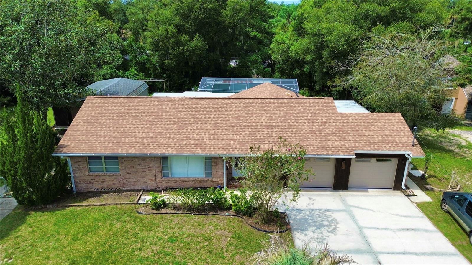 Welcome home! This beautifully maintained three-bedroom, two-full-bath home is located just moments away from Stetson University and historic downtown Deland. Take a dive into this thoughtfully designed residence you will find beautiful oak wood floors throughout, along with spacious living areas that are full of natural light and cedar lined closets in all the rooms. A sizable and well-loved kitchen that has ample cabinetry and pantry space awaits. Just off the kitchen you'll walk into the spacious sunken living room with a beautiful fireplace that is a perfect setup for entertaining. An inside laundry room leads out to a nice-sized storage room that could also be used as your very own secluded office space. Step back in time with a cute little mud room that has an additional exit that leads out to the side yard. This concrete block, brick-stamped home features an oversized two-car garage with functionality and space for all your storage needs. With over a ½ acre lot, there are endless opportunities for all your outdoor activities or needs to expand. A separate well provides all the irrigation needed to have your very own garden and fruit trees. Entertaining family and friends is easy when you have your own private (and screened) nine-foot-deep pool. Adjacent to the main residence is a spacious 20-by-30-foot workshop that has its own driveway entrance. Schedule your private showing today!