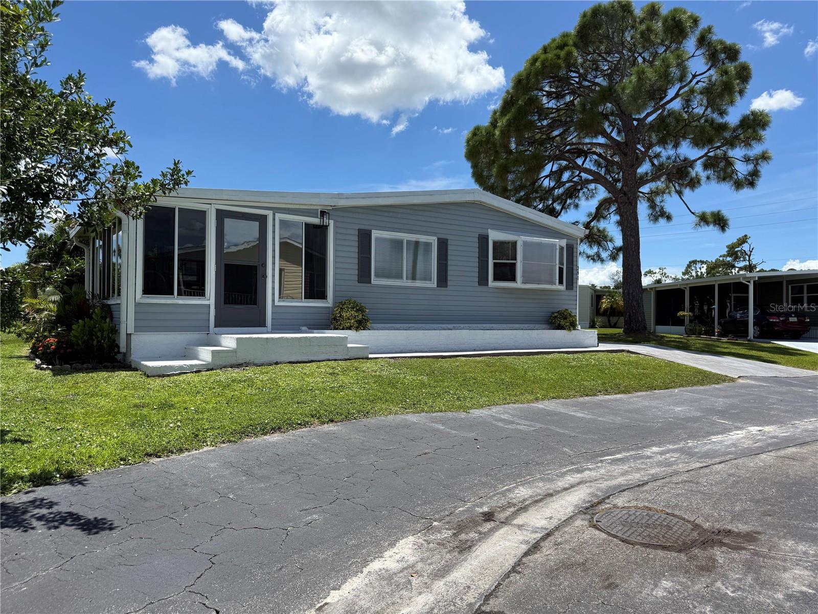 Port Charlotte Village was voted #1 Manufactured home community in Charlotte County for 2024. * Not in a Flood Zone* Inspection is done , the roof is at the end of its life and the seller is offering a $10,000. credit at closing. Move right in—this beautifully furnished 2-bedroom, 2-bath manufactured home in a friendly 55+ co-op community with a low HOA is ready for you! Priced for a quick sale, it offers a long driveway that easily fits two cars. Step inside and you’ll instantly fall in love with the unique, spacious kitchen featuring a built-in desk and a sun-filled bay window. The elegant dining room with a built-in hutch flows into a comfortable living room and a large enclosed side lanai, giving you the perfect mix of style and relaxation. Both bedrooms are generously sized with large closets for plenty of storage. This home has been meticulously maintained with major updates, including a complete HVAC system (2023), full vapor barrier with extra insulation (Dec. 2024), all new gutters (Mar. 2025), reinforced skirting, and fresh landscaping with mulch. The large shed is a bonus, with laundry and a workshop inside—ideal for projects or extra storage. Everything is here—just bring your toothbrush and start living the Florida lifestyle!