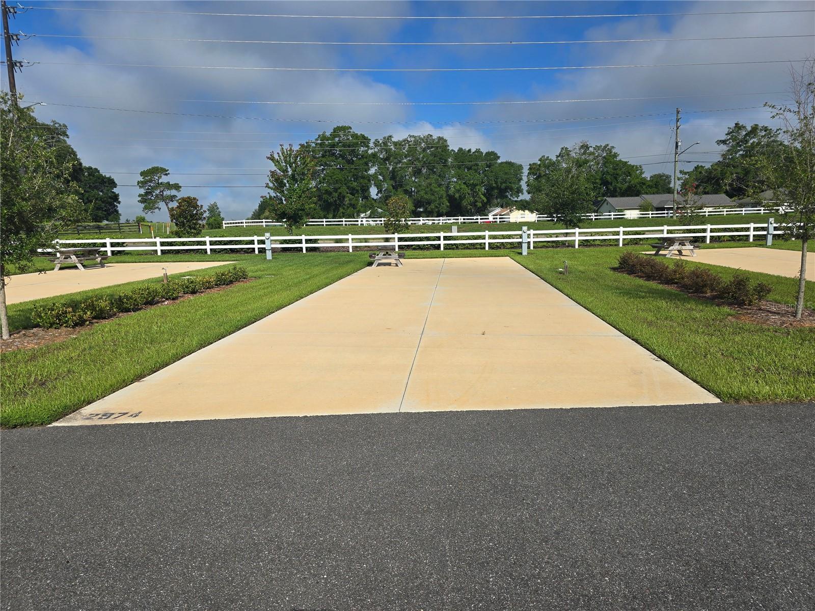 Welcome to your ideal retreat at the always popular Champions Run Luxury RV Resort! This premium RV pad offers a spacious, fully paved site with full hookups, surrounded by lush landscaping and resort-style amenities—including a sparkling pool, clubhouse, fitness center, full-service tiki bar and more. Perfect for personal use for half the year or as a rental investment, this pad is located in one of the area's most desirable luxury RV resorts. Whether you're staying for a weekend or an extended visit, you'll enjoy comfort, convenience, and a welcoming community in a beautifully maintained setting.