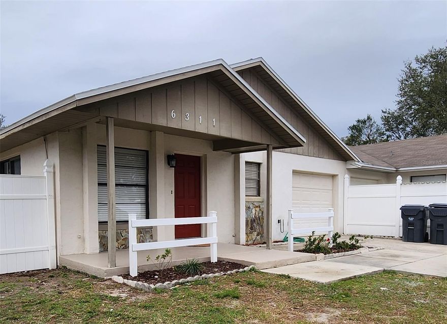 This UPDATED and MOVE-IN READY 3-bedroom, 2-bath half-duplex sits on a spacious CUL-DE-SAC lot with NO HOA and offers 1,350 square feet of beautifully maintained living space. The FRESHLY PAINTED interior and exterior create a crisp, modern look, while newer LUXURY VINYL PLANK flooring in the bedrooms and ceramic tile throughout the rest of the home provide both elegance and easy care—NO CARPET anywhere! The inviting floor plan includes CEILING FANS in every bedroom and a private primary suite featuring an en-suite bath with a tiled walk-in shower. An oversized ONE-CAR GARAGE with electric washer/dryer hookups and an extended driveway provide plenty of parking for guests. Enjoy outdoor living in the FULLY FENCED BACKYARD, perfect for entertaining or quiet relaxation while remaining close to shopping, dining, and everyday conveniences including Publix, Walmart, Sam’s Club, Home Depot, Polk Parkway, restaurants, and shopping, and zoned for the highly regarded GEORGE JENKINS SCHOOL DISTRICT. Great home, great location, great price!!