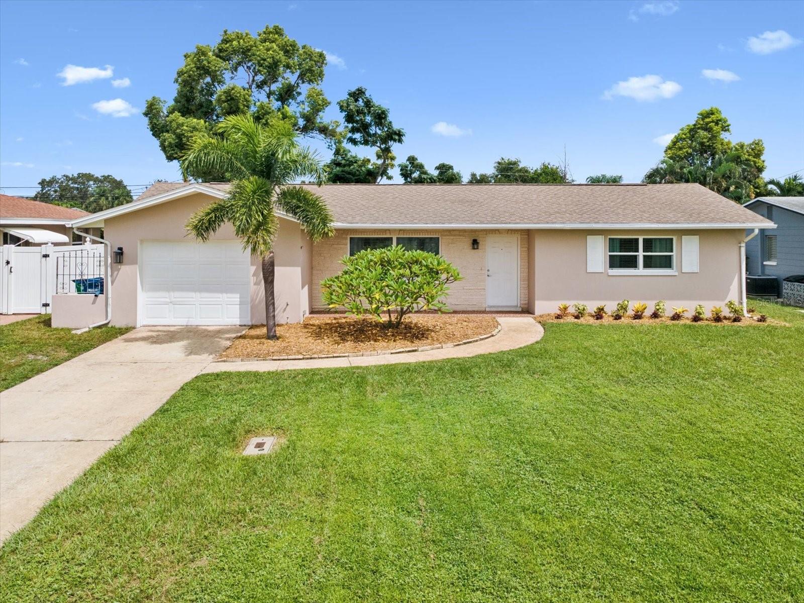 Welcome to this beautifully updated 2-bedroom, 2-bath home in the heart of Incorporated Seminole. Step inside to an inviting open floor plan featuring crown molding throughout, a spacious living room and family room, and a kitchen equipped with stainless steel appliances and granite countertops. The interior was tastefully updated in 2021, showcasing laminate and tile flooring that flows seamlessly from room to room. Major updates provide peace of mind, including double-pane windows (2021), updated electrical (2021), HVAC with new fan motor (2016/2021), a new water heater (2025), and a brand-new roof scheduled for installation in September 2025. Enjoy outdoor living on the screened-in porch overlooking the expansive backyard—plenty of room to design your dream pool or garden oasis. The home also includes a sprinkler system to keep the yard lush year-round. All of this in a prime location less than 10 minutes to Indian Rocks and Madeira Beaches, and just minutes from shopping, golf courses, and beautiful local parks. Move-in ready and decorated with care, this Seminole gem combines modern updates, comfort, and convenience.