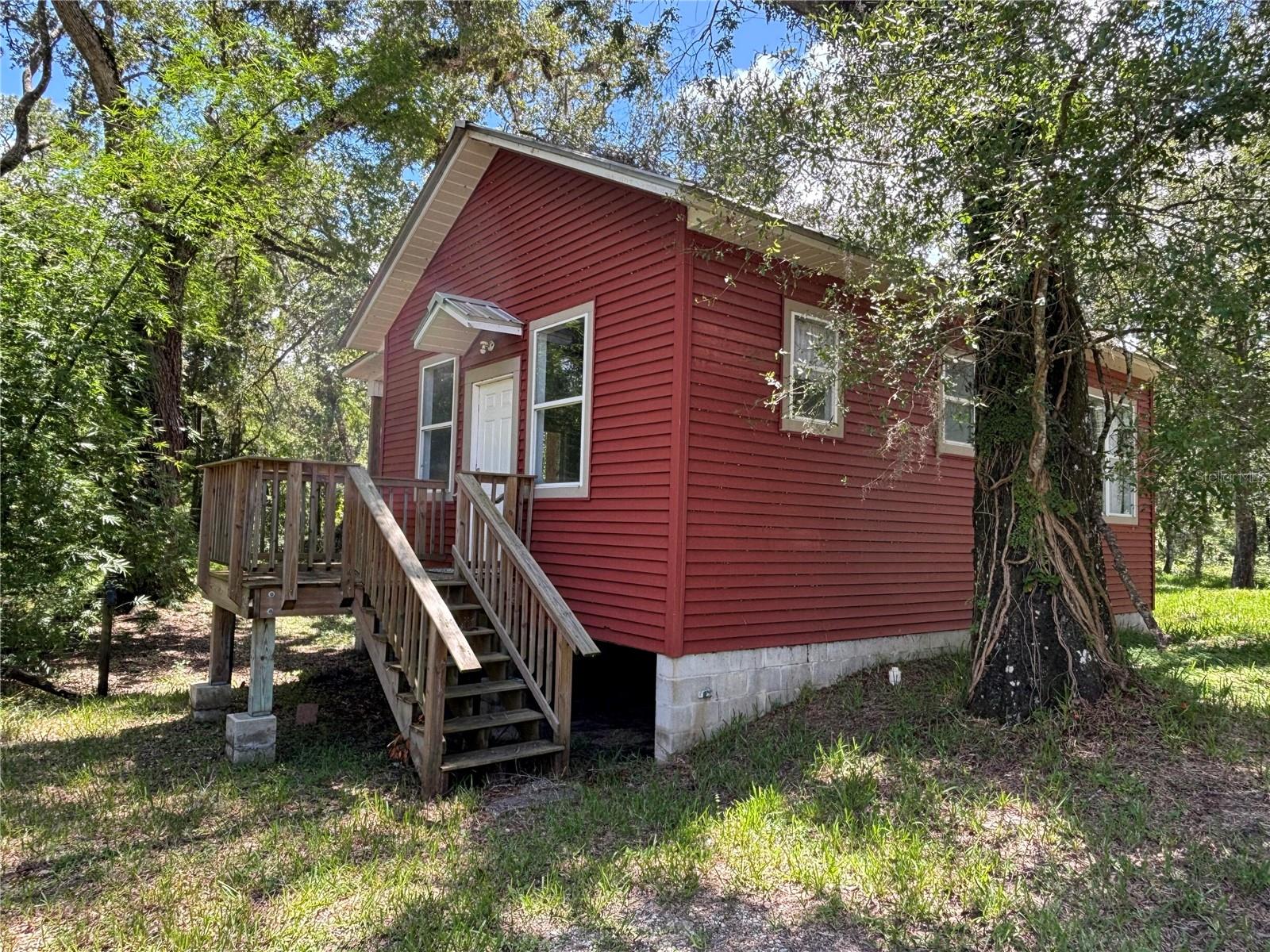 **Charming 2-Bedroom Cottage on the Little Withlacoochee River**
Escape to your own private retreat with this charming 2-bedroom, 1-bath cottage nestled along the tranquil Little Withlacoochee River. Good for nature lovers or those seeking serenity, this home offers a peaceful setting on a quiet private road—where the only sounds you’ll hear are the gentle babble of the river and the rustle of the trees.
Step inside to discover a cozy, sunlit living space with fresh updates throughout. The living room welcomes you with abundant natural light, while the functional kitchen provides everything you need for effortless living. Both bedrooms are generously sized with ample closet space, ensuring comfort and convenience.
The highlight? Your back porch, where you can unwind to picturesque river views and the soothing sounds of flowing water. Whether you're sipping morning coffee or enjoying an evening breeze, this space is pure relaxation.
Rural located off of Highway 301.
The private dirt road has fallen into disrepair although the local residence are working together to help repair it.
Don’t miss this opportunity to own a slice of riverside paradise.
