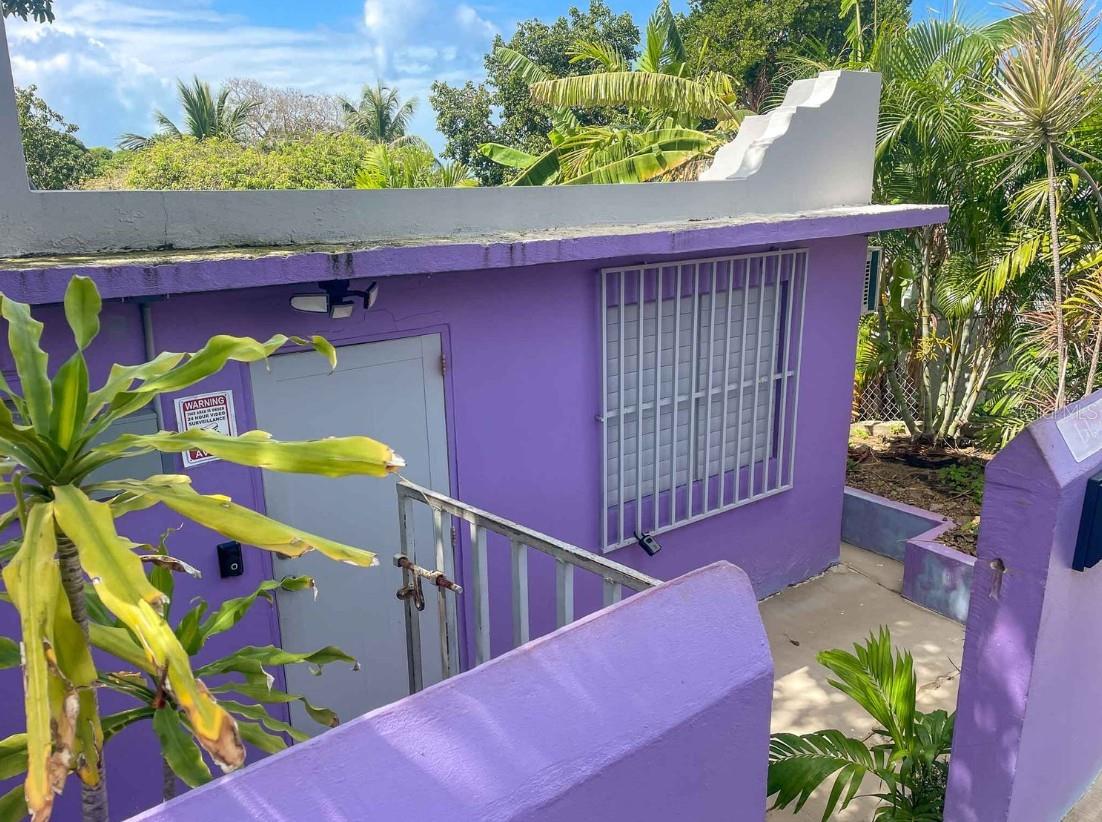 Imagine starting each day with the soothing sounds of a creek flowing gently through your backyard as you relax on a covered wooden deck, enveloped by Vieques' lush, natural beauty. Welcome to "La Iguana Morada," a distinctive three-bedroom concrete home offering both the comforts of modern living and the enchanting allure of island life in Puerto Rico.
Upon entering La Iguana Morada, you are greeted by a spacious living room with a welcoming sofa and TV setup—perfect for entertainment or a relaxing evening. The entire home features tiled flooring, which complements the practical and stylish aesthetic. Each bedroom is fitted with air conditioning, ensuring comfort regardless of the season. The bathroom offers a unique touch with its stone pebble-floored shower, adding a splash of island elegance.
The real jewel of this home is its expansive covered deck, which is screened to meld indoor comfort with an outdoor ambiance. It's an ideal spot for enjoying the tranquil views of the creek and lush surroundings, whether you're dining, entertaining, or simply unwinding.
Strategically situated at the base of the historic El Fortin de Conde Mirasol Museum and just a short drive from the vibrant town center of Isabel Segunda, this property offers both tranquility and convenience. Shops, restaurants, and the ferry terminal are all within easy reach, enhancing your living experience with simplicity and style.
Despite lacking a formal title, which is a common scenario in unique real estate markets like Vieques, La Iguana Morada has demonstrated significant earning potential. It boasts a successful rental history, generating over $25,000 per year, making it an excellent investment for those looking to enter the rental market or maintain a steady income stream.
Vieques is famed not only for its picturesque beaches and diverse restaurants but also for its iconic Vieques BioBay, known for its mesmerizing bioluminescent waters. Living here means embracing a lifestyle where nature's beauty is always a backdrop to your daily activities, from dining under the stars to exploring the vibrant underwater life.
If the blend of substantial rental income, breathtaking natural surroundings, and a vibrant community appeals to you, La Iguana Morada is ready to fulfill those dreams. Contact Paraiso Realty today to discover more about this property and how we can assist you in making your Caribbean lifestyle a reality. Together, we'll ensure your journey to owning a home in Vieques is as rewarding as the destination itself.