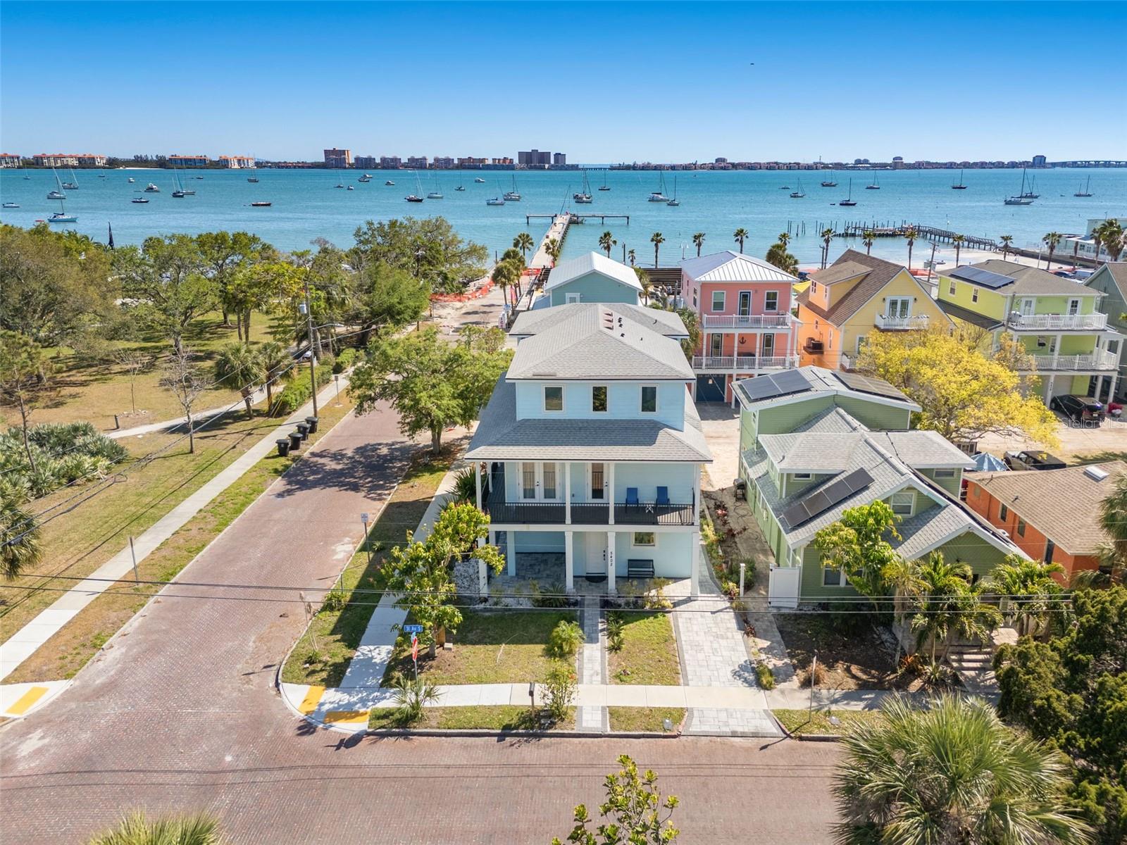 Newer construction modern coastal style home right in the heart of Gulfport. One block from the water and mere steps from all of the local favorites on Beach Drive. This three-level block construction home is a fortress with impact rated windows and doors. The oversized garage and corner lot provide ample parking for cars, golf carts, boats, and anything else you can think of. All five bedrooms have their own ensuite and each floor boasts a separate powder room. The open concept kitchen stuns with quartz countertops, soft close shaker cabinetry, high end Samsung appliances, and luxury lighting fixtures. Surrounding the entire second floor is a beautiful wrap around porch with marvelous water views that provide the perfect space for entertaining and taking in the Florida sunsets. The water views are further amplified off the third floor balcony beyond the loft and wet bar. Your own private elevator connects each floor making this residential masterpiece functionally flawless. Smart home features include a complete home security system, cameras, MyQ garage doors, and a Schlage smart lock. Other amazing features are the luxury vinyl flooring throughout, Eemax tankless hot water heater, recessed energy efficient LED lighting, and it can come fully furnished. For the investor looking to add a crown jewel to their portfolio please inquire about the financials and pro forma projections. Call today and be the envy of family, friends, and neighbors!