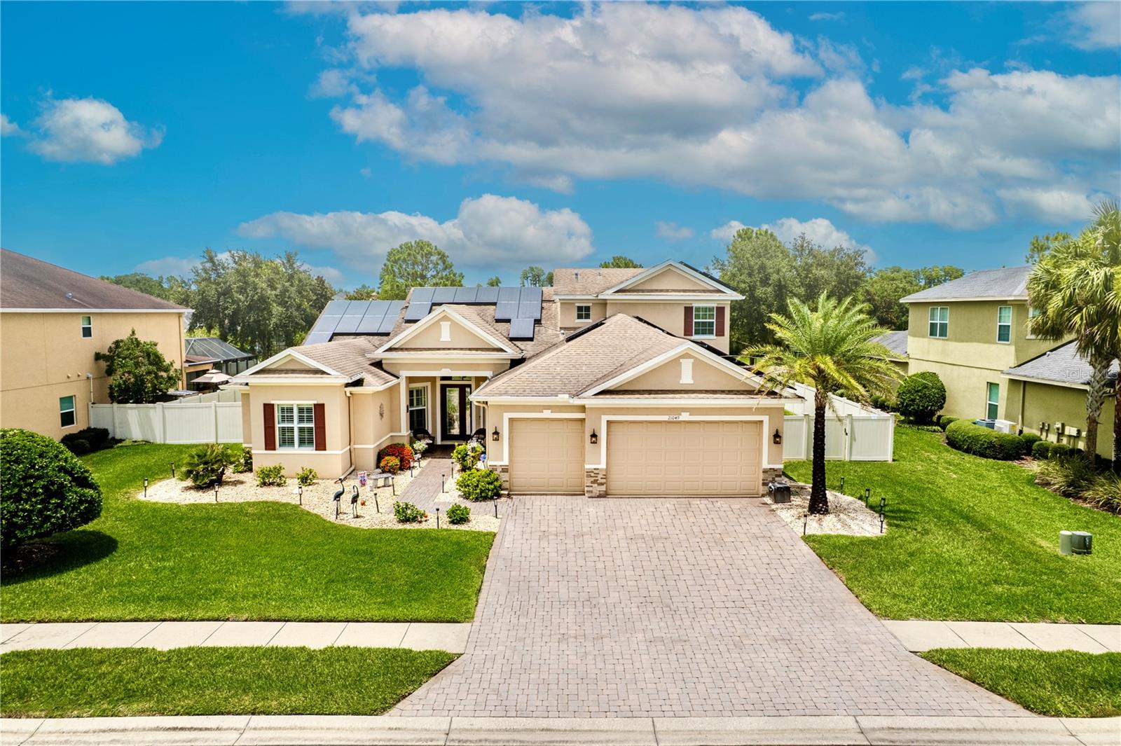 Welcome to your dream home in the exclusive gated community of Lake Thomas Pointe! This meticulously maintained Taylor Morrison "Brentwood" Model features 4-bedroom + office + loft, 4-bathroom, 3-car garage estate offers the best of Florida living, situated on just under a 1/3-ACRE HOMESITE WITH NO REAR NEIGHBORS AND SERENE POND AND GREENBELT VIEWS. From the moment you arrive, the curb appeal impresses with a stone elevation, paver driveway and lead way, and glass-inlay front door with sidelight. Inside, you'll find crown molding, plantation shutters, engineered hardwood flooring, and arched doorways enhancing the home's elegance. A formal dining and living room filled with natural light welcomes you with sliding glass doors that open directly to the lanai. To the left, a private office with French doors and hardwood flooring offers a peaceful workspace. The primary suite is a true retreat, featuring tray ceilings with custom cypress wood detail, dual walk-in closets, and a luxurious en-suite with his-and-hers granite vanities, walk-in shower, soaking tub, private water closet, and linen storage. At the heart of the home, the gourmet kitchen showcases upgraded granite countertops, tile backsplash, 42” staggered cabinetry, stainless steel appliances, single-basin sink with air switch disposal, walk-in pantry, and spacious breakfast nook with pool views. The kitchen flows seamlessly into the expansive family room, perfect for entertaining. The first floor also includes two additional bedrooms with a shared Jack-and-Jill bathroom, a full pool bath with glass-enclosed shower, a generous under-stair storage closet, and an oversized laundry room with utility sink and hallway access. All bedrooms downstairs feature engineered hardwood floors. Upstairs, you'll find newer carpet, a spacious loft, guest bedroom, and another full bathroom, creating an ideal space for multigenerational living or private guest quarters. Enjoy the Florida lifestyle from your custom backyard oasis, featuring a trussed lanai, recently resurfaced(2025)heated saltwater pool with laminar water features, extended pavers, cypress wood ceiling, fans, nebula screen cage lighting, built-in surround sound and a screen-enclosed outdoor kitchen with grill, bar fridge, and abundant storage. Multiple access points to the lanai—including triple-pocket sliders, a sliding glass door and a French door off the pool bath—ensure easy indoor-outdoor flow. Additional upgrades include a SolarEdge 15.00 kWp OWNED solar panel system with 50 panels, two inverters, and optimizers, as well as a built-in central vacuum system. Located just moments from major highways, shopping, dining, and zoned for top-rated schools, this fully upgraded Taylor Morrison home offers the perfect blend of luxury, privacy, and convenience. Lake Thomas Pointe is an enclave situated on the southern shore of 180 acre Lake Thomas with community features including a boardwalk, dock and gated entry. Don't miss your opportunity to own a piece of paradise-schedule your showing today!
