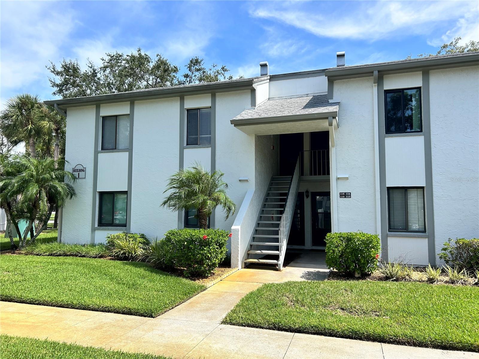 Gorgeous updated and immaculate 2 bedroom/2 bath condo in the desirable gated community of East Lake Woodlands. Split plan with large primary bedroom featuring 2 walk-in closets, beautifully renovated ensuite bath, linen closet, and sliders leading to private rear porch and patio area. The spacious secondary bedroom features a large closet and adjacent remodeled guest bath. Kitchen has been updated with extra storage and counter space added, and features a large closet pantry for storage, stainless steel appliances, granite countertops and wood cabinetry. Large living room/dining room combination with sliders lead to private rear porch with washer/dryer closet and a patio area beyond. No rear neighbors, with tranquil nature and golf course views. The rear porch has windows with screens for year-round enjoyment, and updated windows in the kitchen and bedrooms provide security and energy efficiency. Crown moulding in living/dining room and both bedrooms; porcelain tile in kitchen, bathrooms and living areas; plush carpet in bedrooms. Super convenient area - close to schools, shopping, restaurants, beaches and parks, airport, and hospital. Annual lease, no smoking, one small pet welcome.