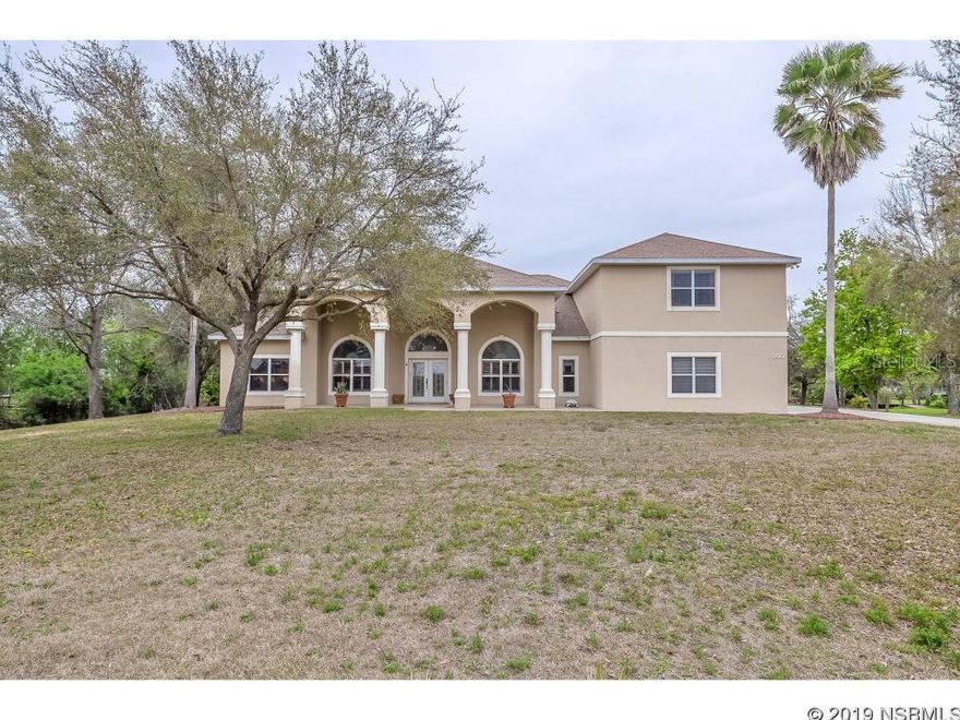 Come live in the country! A ''Quiet Place in the Country'' is where you will find this spacious, customized Johnson Group built home w/their ''safe room'' feature. Set on 1.29 acres, this home boasts 4 bedrooms and 4 baths, plus a 3 car garage, a den or office, a screened Lanai w/Summer Kitchen, a large patio and a detached ''pool house'' that can also be used as a man cave, home gym or anything else you want! There are so many possibilities. Enter through the double glass panel front doors to a large bright foyer that features the Formal Living Room on one side & the Dining Room on the other. The Family Room is the at the back of the home & has a wet bar for entertaining. Adjacent to the Kitchen, this space will be perfect for all your family gatherings. The Family Room also features a fireplace & built in "niches" for displaying your collectibles or art work. The "chef" in your family will love large kitchen that has an island with cook top, Granite counter tops, stainless steel appliances, double ovens, and an "office nook". The Owner's Suite measures approx. 30x15 and has a separate sitting area w/a fireplace & sliders to the patio that overlooks the pool area. The attached private bath comes w/ dual vanities, a large walk-in tiled shower, a garden tub and large closet. Two other bedrooms share a Guest Bath and a 4th bedroom above the garage has its own bathroom. There is also a "bonus room" that is currently used as an office that has a Murphy bed and full bath with pool access. Sliders in the Family Room lead to the screened Lanai that has a Summer Kitchen, ceiling fans and direct access to the large paver patio & pool area. A detached "pool house" with A/C is located at one end of the patio and can be used as a home gym or anything you want! Just a few steps away is the 40x16 heated pool with paver decking and a safety fence. This home has so much to offer. Located in the country, yet close to everything you need like shopping, dining & entertainment.