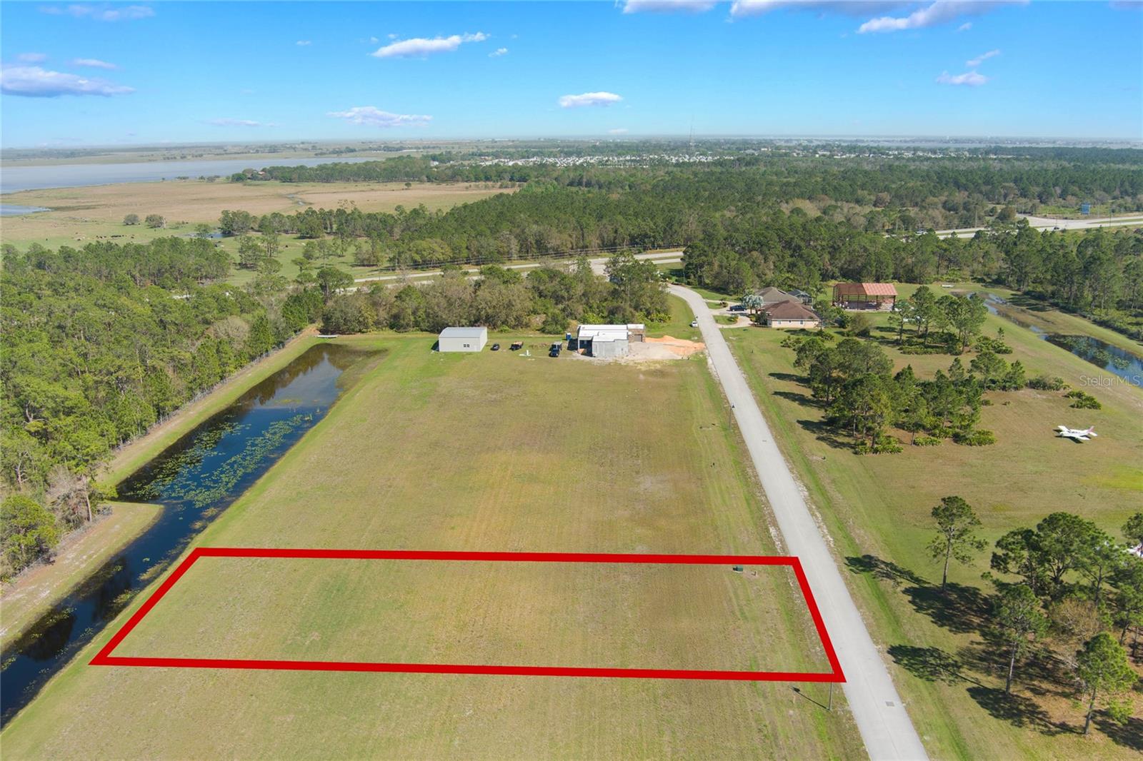 WELCOME to Ridge Landing Airpark, a premier luxury aviation community! This exceptional 0.91-acre building lot is a rare opportunity for aviation enthusiasts and those seeking a tranquil, scenic retreat. Located just moments from a private, paved runway, Lot #94 offers easy access for private aircraft owners. With its generous size, this lot provides plenty of space to build your dream home with a custom hangar, all within the vibrant Ridge Landing community. The lot is nestled in a peaceful, gated environment, perfect for those desiring privacy and serenity. The property is conveniently located near major routes, including US Highway 27, providing easy access to nearby cities. Local amenities such as shopping centers, schools, and healthcare facilities are just a short drive away. Additionally, Lake Walk-in-Water, a popular fishing and boating destination, is within close reach for outdoor enthusiasts. Ridge Landing Airpark offers stunning natural views and is surrounded by Florida's renowned beauty, with nearby parks and recreational areas. The community’s private runway and aviation-friendly features make it an ideal location for aviation lovers and those seeking a unique lifestyle. Don’t miss out on this unique chance to own a slice of paradise in one of Florida’s premier luxury airparks.