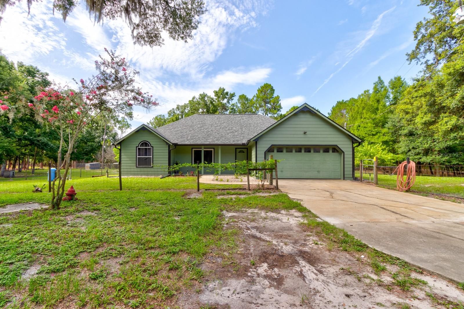 Welcome to your private 9-acre homestead retreat in the heart of Pierson! This beautifully updated 3-bed, 2-bath farmhouse may be cozy in size, but it’s big on charm, comfort, and lifestyle.
Step inside and you’ll find a home that feels brand new — with a 2025 roof, fresh paint inside and out, upgraded plumbing, water filtration and softener system, and a 2021 water heater. Vaulted ceilings, an open layout, and an updated kitchen and baths make the home feel bright and spacious.
Outside, the property truly shines. The acreage is a perfect blend of usable fenced pastures and natural wetland buffers that provide peace, privacy, and wildlife views. Whether you’re dreaming of a hobby farm, raising animals, or simply enjoying the outdoors, this property is move-in ready with:
A 4-car detached concrete block garage.
320 sq. ft. air-conditioned outbuilding – ideal for a studio, guest suite, or home office.
A climate-controlled shipping container for storage.
Chicken coop with laying hens already in place.
Fruit trees including bananas, blueberries, pineapples, and blackberries.
Screened porch, front porch, and multiple patios to enjoy Florida’s sunsets.
Located across from Lake George Wildlife Management Area and just minutes to boat ramps, DeLand, and the beaches, this property offers the perfect balance of seclusion and convenience.
With all the major updates completed, fenced acreage, and versatile outbuildings already in place, the heavy lifting has been done — just bring your vision and start enjoying your Florida country lifestyle from day one.
All information deemed reliable but not guaranteed. The 3rd bedroom does not have a closet, but county records list home as a 3 bdrm. Buyer is responsible for verifying all information, including but not limited to square footage, acreage, zoning, permitted uses, and school districts. Seller and Broker make no warranties, expressed or implied. Property is being sold as-is.