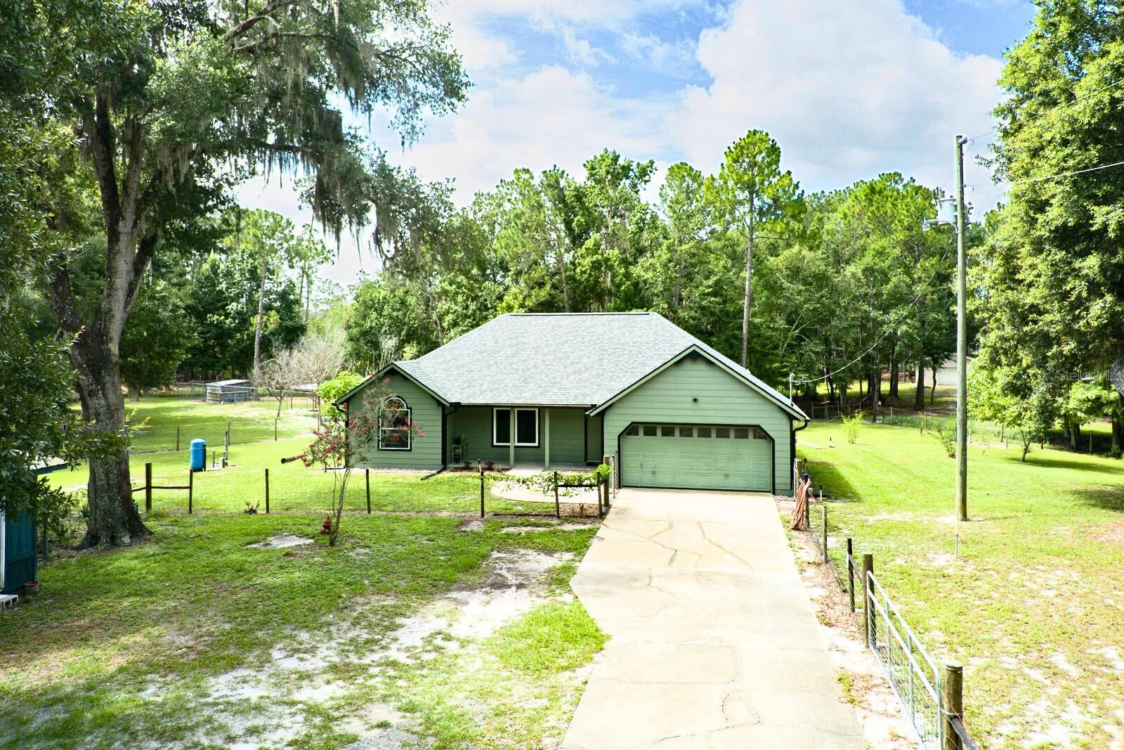 Welcome to your private 9-acre homestead retreat in the heart of Pierson! This beautifully updated 3-bed, 2-bath farmhouse may be cozy in size, but it’s big on charm, comfort, and lifestyle.
Step inside and you’ll find a home that feels brand new — with a 2025 roof, fresh paint inside and out, upgraded plumbing, water filtration and softener system, and a 2021 water heater. Vaulted ceilings, an open layout, and an updated kitchen and baths make the home feel bright and spacious.
Outside, the property truly shines. The acreage is a perfect blend of usable fenced pastures and natural wetland buffers that provide peace, privacy, and wildlife views. Whether you’re dreaming of a hobby farm, raising animals, or simply enjoying the outdoors, this property is move-in ready with:
A 4-car detached concrete block garage.
320 sq. ft. air-conditioned outbuilding – ideal for a studio, guest suite, or home office.
A climate-controlled shipping container for storage.
Chicken coop with laying hens already in place.
Fruit trees including bananas, blueberries, pineapples, and blackberries.
Screened porch, front porch, and multiple patios to enjoy Florida’s sunsets.
Located across from Lake George Wildlife Management Area and just minutes to boat ramps, DeLand, and the beaches, this property offers the perfect balance of seclusion and convenience.
With all the major updates completed, fenced acreage, and versatile outbuildings already in place, the heavy lifting has been done — just bring your vision and start enjoying your Florida country lifestyle from day one.
All information deemed reliable but not guaranteed. The 3rd bedroom does not have a closet, but county records list home as a 3 bdrm. Buyer is responsible for verifying all information, including but not limited to square footage, acreage, zoning, permitted uses, and school districts. Seller and Broker make no warranties, expressed or implied. Property is being sold as-is.
