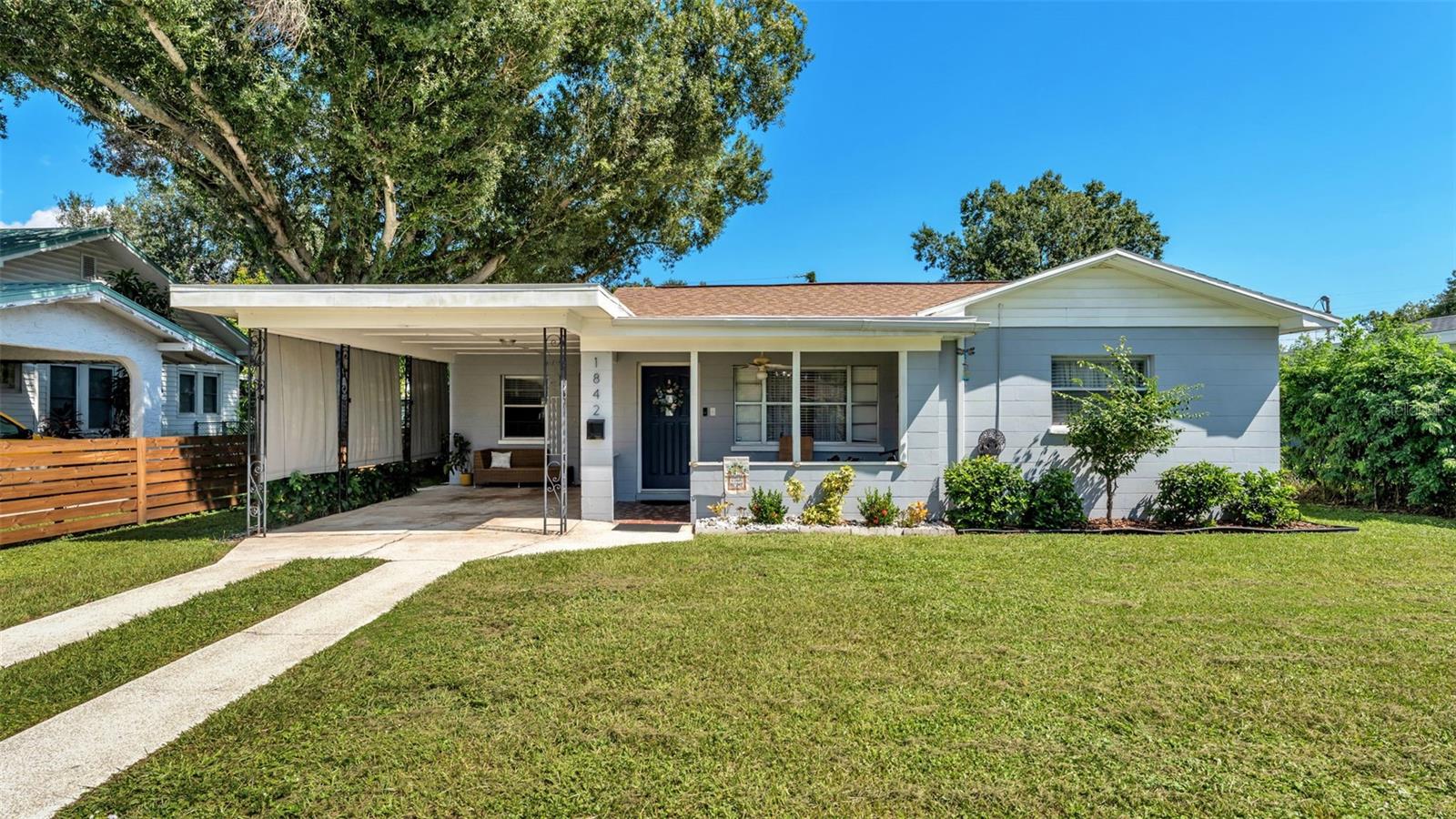 Welcome to 1842 E Main St, a charming and cozy home offering 1,020 square feet of air-conditioned living space and a total of 1,440 square feet under roof, including the convenient carport. This thoughtfully designed property features 3 bedrooms, 1 full bathroom, and 1 half bathroom, along with an internal laundry room that opens directly to the spacious backyard—ideal for ease and functionality. Step inside through the inviting open front porch that overlooks a fully fenced yard, complete with a gate entry and decorative wooden fencing that enhances the charm and privacy of the home. Sitting on a 0.19-acre lot, there's plenty of room to enjoy the outdoors in both the front and back yard. Inside, you’ll find tasteful updates throughout the home, creating a warm and comfortable ambiance. The floor plan offers a smart layout: one bedroom is conveniently located adjacent to the half bathroom, while the remaining two bedrooms share access to the full bathroom via a central hallway. The kitchen not only offers views of the backyard but also features its own access door to the carport—perfect for unloading groceries with ease. Ideally situated just minutes from downtown Lakeland, you’ll enjoy close proximity to local favorites such as The Joinery food hall, Lake Mirror, Nineteen61, Bar Vasco, Smith's American Tavern, Tennessee Jane boutique, Palace Pizza, and several salons. Plus, you’re just a short drive away from lively community events like the Saturday Farmers Market and First Fridays. This home blends comfort, charm, and convenience in a highly desirable location—don’t miss your chance to make it yours!