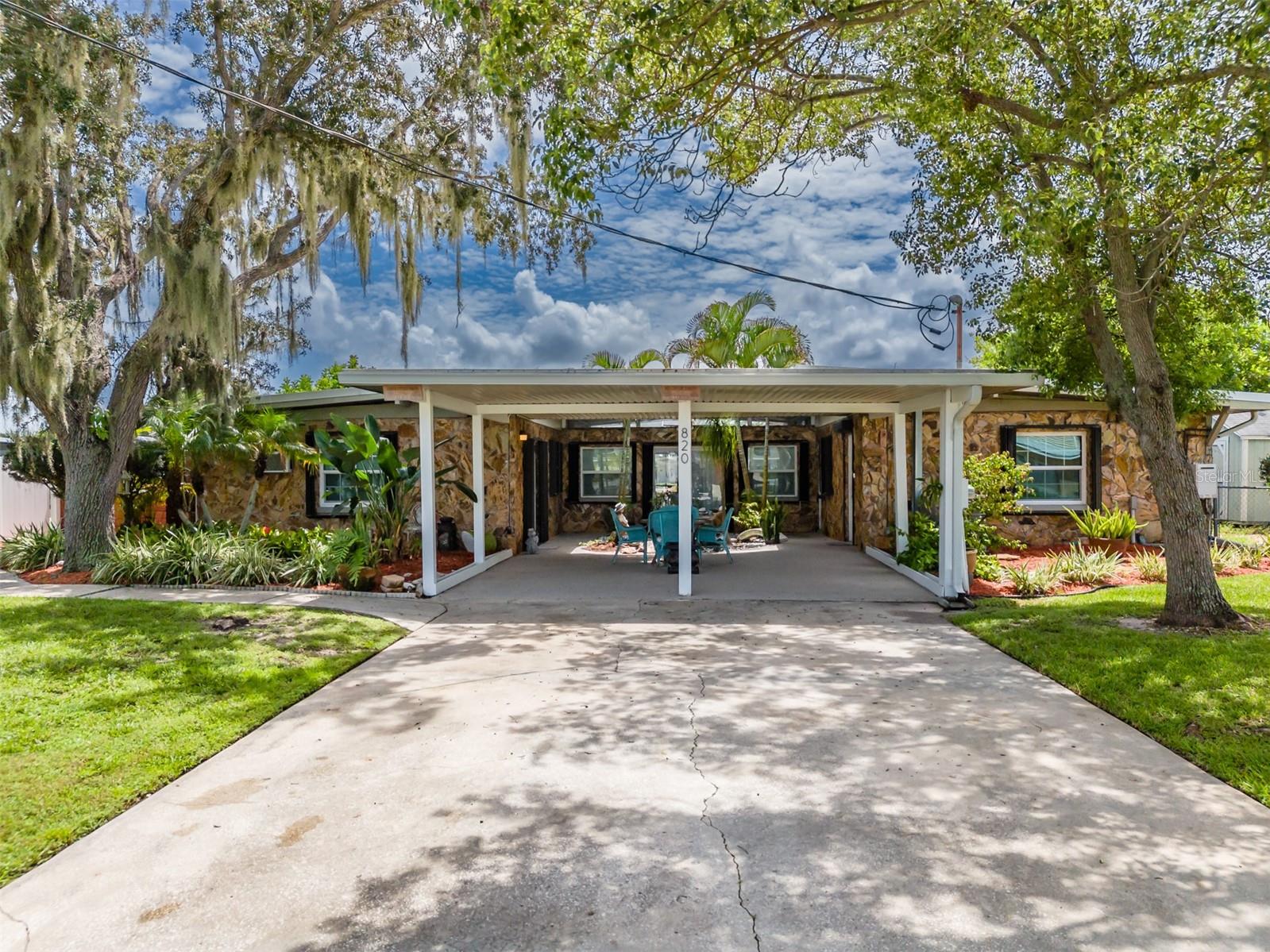 This fully furnished 3-bedroom, 4-bath waterfront home is an ideal choice for families or as a VRBO property. Currently an active income-producing asset, it boasts numerous updates and modern features. The newly remodeled, open and airy kitchen is a standout, with quartz countertops, abundant upgraded cabinetry, stainless steel appliances, and a gas range with a sleek range hood. A large island with a bar top and a stylish shiplap wall enhance the space. The dining area features built-in shelves for added convenience. The cozy family room is bathed in natural light, featuring a wood ceiling, stone walls, and multiple glass sliders that open to the courtyard, pool, and Lanai. It also offers stunning water views. The primary suite includes a barn-style sliding door, plantation shutters, and French doors leading to the sunroom. The en-suite bathroom features a stand-alone clawfoot tub, dual sinks, and a spacious walk-in closet. The second bedroom overlooks the water and includes a full bathroom and a walk-in closet. The third bedroom functions as an in-law suite or small apartment, complete with a separate French door entrance, a kitchenette (including a refrigerator, sink, microwave), and a full bathroom. The sunroom also offers water views and includes a new mini-split AC unit, and a bathroom with a frameless shower. Glass sliders provide access to the pool and lead to the boathouse and dock. Enjoy cocktails by the refreshing pool, which features a swim-up table and overlooks the water. The stand-alone hot tub and spacious Lanai offers ample space for grilling and outdoor entertaining. The fenced backyard, with tropical landscaping, includes a large, insulated storage shed. Bring your boat— the boathouse features a center console lift with a 7,500 lb capacity, and there's also a dock for fishing. Additional upgrades include a metal roof (5 years old) with hurricane straps, a new Trane heat pump air conditioner, wide plank luxury vinyl flooring, easy-close built-in hurricane shutters, new energy-efficient windows, an on-demand gas heater, and a 110-gallon above-ground propane tank, New Rheem water heater, new epoxy surface carport and pool, new pool pump, New hot tub, new appliances and cabinets, new 2nd bath with tile, 3rd br (apt) bath with full tile shower. The seawall, recently rebuilt, is in excellent condition. The pool is handicap accessible. Located on a wide Ruskin inlet with direct access to Tampa Bay without any bridges, this property generates approximately $68,000 annually.