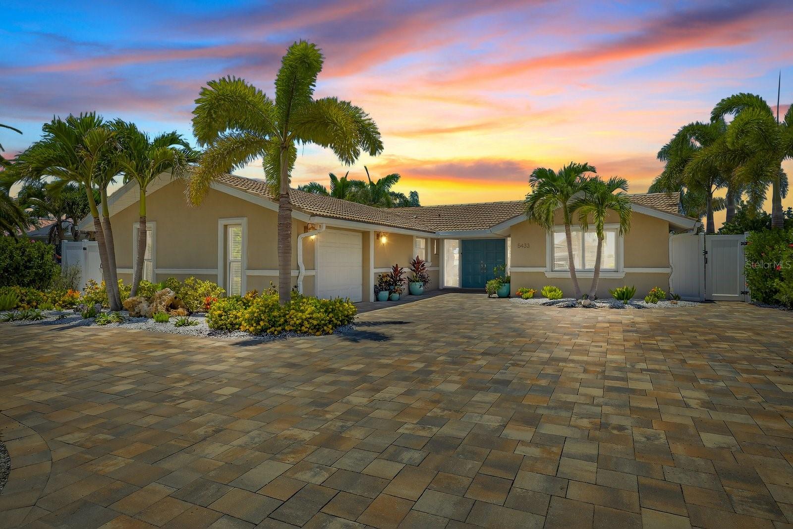 Welcome to the Good Life on Leeward Lane!
If you’ve been dreaming of a waterfront home that’s made for entertaining, soaking up sunsets, and living every day like a vacation—5433 Leeward Ln in Gulf Harbors delivers it all and then some. Set on a quiet canal with dolphins, manatees, and turtles as your neighbors, this tropical oasis brings you the very best of Florida’s resort-style living—from the waterfall in the saltwater heated pool to the custom outdoor kitchen and the BEST BONUS is the paid-off solar system that keeps your power bill around $30 a month (yep, really!).
As you pull into the pavered circular driveway, you’ll notice the curb appeal right away—lush landscaping, mature palms, and a welcoming double-door entrance. Inside, you’ll find a smart and stylish layout with plank tile flooring throughout, a split floor plan, and a light-filled kitchen complete with white shaker cabinets, soft-close drawers, walk-in pantry, and a built-in side bar/buffet that’s perfect for hosting.
The primary suite has its own mini-split A/C, his-and-hers closets, and a spa-like vibe. And the XL guest bedroom makes sure your visitors feel right at home. Bonus perks include two updated 200-amp panels, temperature-controlled attic storage, and peace of mind with an updated seawall!
Step out back and it’s pure paradise—screened lanai, pool bath, pavered sun deck, complete with irrigation system, landscape lighting, and a beautiful custom kitchen with built-in fridge, sink, grill, and ice maker. You’ve also got a PVC stationary dock with floating platform, ideal for boating, paddleboarding, kayaking, or jet skiing right from your backyard.
All this in Gulf Harbors, one of the area’s most loved boating communities, offering a private beach club for just $200/year, community boat ramps, and an optional HOA of only $125/year. Cruise your golf cart to downtown New Port Richey, cruise out to the Anclote island and sandbar, or just stay home and catch the best sunsets on the Gulf coast from your own dock.