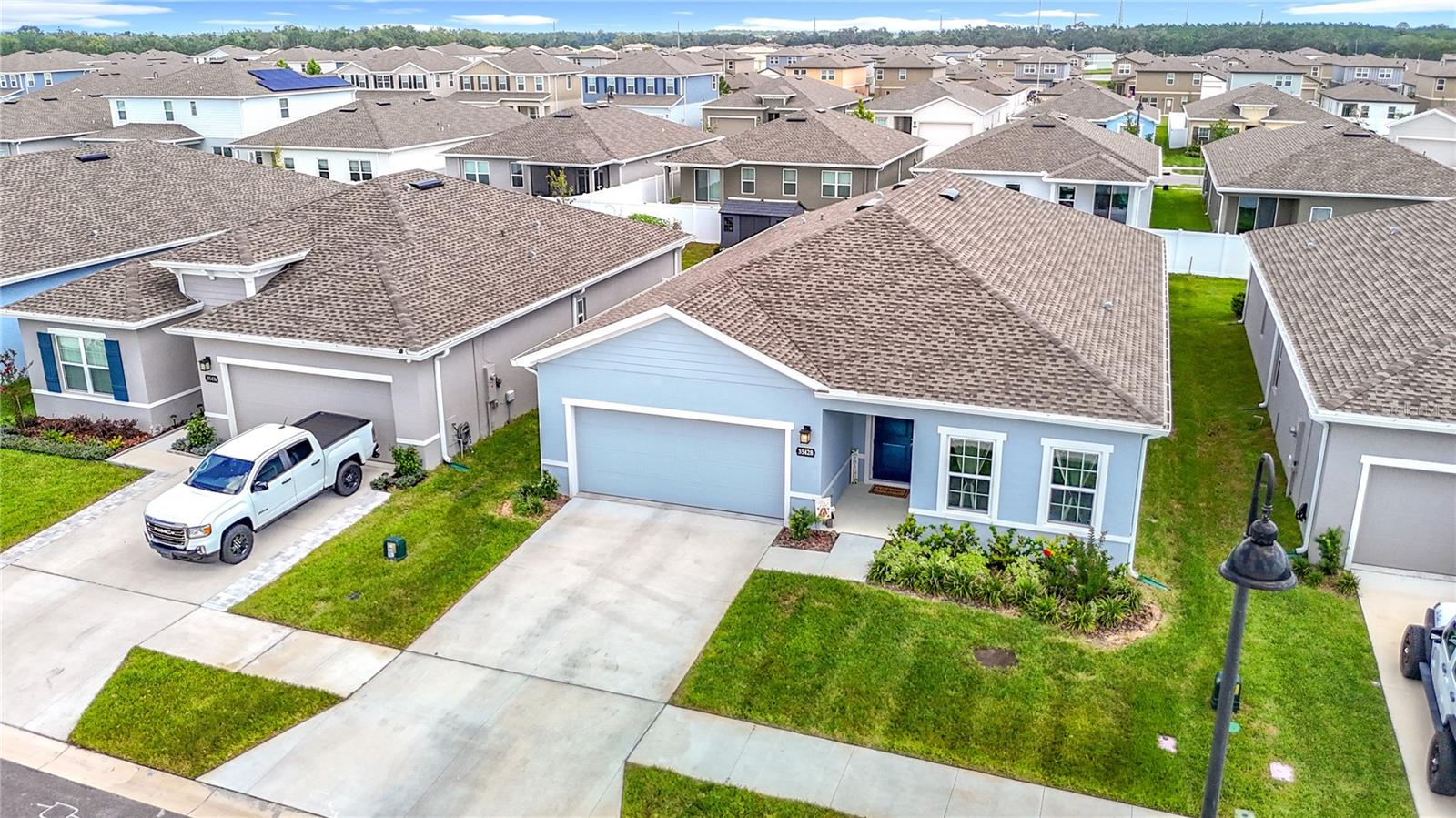 Why wait to build when you can have it now! Less than 1-year NEW home. Ryan Home's popular Panama Model 4 bed 2 bath Smart home lives large at 2021 sf living space. As you enter the foyer, you'll note the Oversized tile that flows throughout the home seamlessly, this coupled with the Wide-Open Great Room & Upgraded Kitchen makes this home live larger than it already is. The Kitchen is a Chef's delight offering Counter Height Island with seating, Granite counters & Chic light grey cabinets, Stainless cooktop & Double Oven! Samsung SmartThings Top of the line Refrigerator w changeable color panels and huge pantry to top it off. This Floorplan offers great flexibility, Generous Great room with Dining area and Large Cafe off the kitchen to utilize as you wish. The cafe and kitchen area have a nice view of the Truss Covered Lanai & nice backyard. The Modern decor and neutral colors give this home a Casual Elegance coupled with the low maintenance flooring. The bedrooms are on a double split plan with the Owners Suite featuring Ensuite Primary bath w His & Hers Sinks w Vanity area quartz counters on soft grey cabinets and large Shower w built in seat. The Walk In Closet is amply sized and offers plenty of storage for everyone. There are 2 large bedrooms & Secondary Full bath w double sinks and Tub/Shower combo towards the front of the home and an additional 4th bedroom that is split on the opposite side perfect as an office or private guest room. Other interior upgrades are Smart home features such as Eco bee smart Thermostat, Genie Aladin Smart Garage Door opener and Ring Doorbell to keep you connected, 5-inch baseboards throughout & upgraded ceiling fans in every room. Exterior features include White Vinyl fencing (partial) Irrigation using reclaimed water (front & sides) and Gutters on a 120 feet deep lot for plenty of backyard space. This home has something for everyone! Chapel Creek has a Pool, Playground and 2 dog parks, LOW HOA, NO Flood insurance required, convenient to Shopping, Dining and I-75. Look no further for your NEW Home. Call Today!