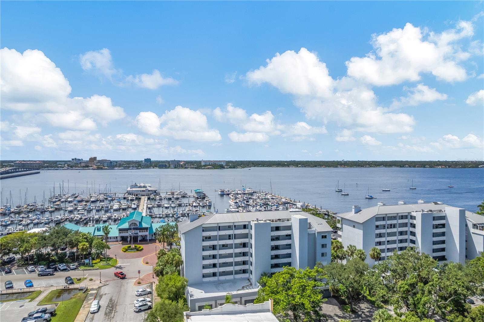 Welcome to Regatta Pointe—where every day feels like a vacation. Located in the historic district of Palmetto, this stunning, fifth floor, end unit residence combines elegant upgrades with unmatched views of the waterfront from the Braden River to Warner Bayou on the Manatee River. With 1,590 sq. ft. of living space plus an expansive 455 sq. ft. wrap-around, covered balcony, you’ll enjoy endless opportunities for outdoor relaxation just watching the boating activity at the marina's or entertaining friends and or family.
Inside, engineered hardwood and tile floors flow throughout a light-filled open layout. The updated kitchen and baths (with new Stainless Steel appliances in 2024) provide a fresh, modern feel, while a cozy fireplace adds warmth to the living room. The primary suite and living area both open onto the balcony through sliding glass doors (replaced in 2017), offering seamless indoor-outdoor living. Additional conveniences include a washer/dryer in-unit, two secure garage parking spaces, and roll-down hurricane shutters for peace of mind.
Regatta Pointe residents enjoy resort-style amenities including a heated pool, fitness center, secure lobby, elevator, and a 6th-floor clubhouse with a full kitchen and panoramic views. This exceptional condo combines luxury, comfort, and waterfront lifestyle—ready for you to move right in.