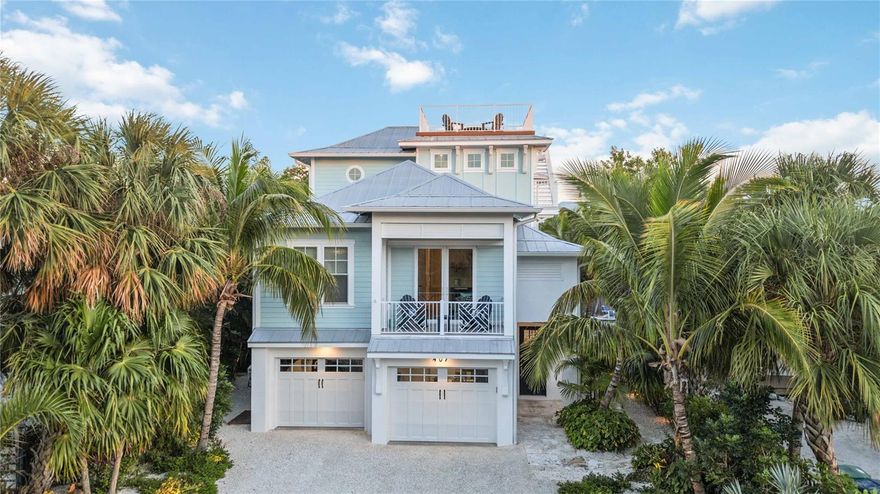 ROR Zoning & Short Term Rentals Allowed!  Experience the epitome of luxury coastal living at 407 Pine Avenue on beautiful Anna Maria Island! Smart Home devices allow for EASY HOME MANAGEMENT and monitoring while you are away. Custom designed and professionally decorated, this 4-bedroom, 4.5 bathroom private residence is nestled right in the heart of Anna Maria offering a special blend of upscale amenities nearby including acclaimed local restaurants, boutique shopping and a kayak launch for adventure seekers! As you approach the home, you are greeted by a custom-cut Key West Coral entry path leading to an inviting foyer equipped with an elevator for your convenience. Hardwood flooring flows elegantly throughout this home highlighted by luxe finishes in every room. Step into the grand open living area properly designed for relaxation and enjoyment. The light filled coastal kitchen is perfect for entertaining featuring an oversized island adorned with quartz countertops, a gas range and energy efficient built-in stainless-steel appliances. The expansive primary suite features a vaulted ceiling, a spacious sitting area, a luxurious bathroom, walk-in closets and a private outdoor covered deck to enjoy gentle gulf to bay breezes. Each ensuite guest bedroom has its own bathroom. Notably, one bedroom serves as a private guest pool house suite, accompanied by a bonus room adjacent to the pool area providing an exclusive retreat for guests. A dedicated den/office space with sliders and a covered deck delivers an ideal vantage point to appreciate the sights and events along Pine Avenue. For a panoramic view of Anna Maria Island, ascend to the rooftop deck to capture 360-degree views of inspiring sunrises & gorgeous sunsets! An outdoor sanctuary has been designed for ultimate relaxation, featuring both covered and uncovered seating areas, a gas fireplace and a large pool with spa enriched by stone pavers and all-weather Trex decking. As evening sets in, professional landscape lighting accentuates this tropical oasis creating an exceptional opportunity to unwind and immerse yourself in the peaceful tranquility found only on Anna Maria Island! Pristine and Model Perfect in every way! This amazing property has been carefully managed and meticulously cared for by its owners who take great pride in the maintenance of this home, and it shows! The property conveys completely TURN-KEY furnished PLUS the sellers are INCLUDING a nearly new SIX PASSENGER GOLF CART, an electric powered beach wagon, house tools and beach gear. All that you need to bring is YOU!