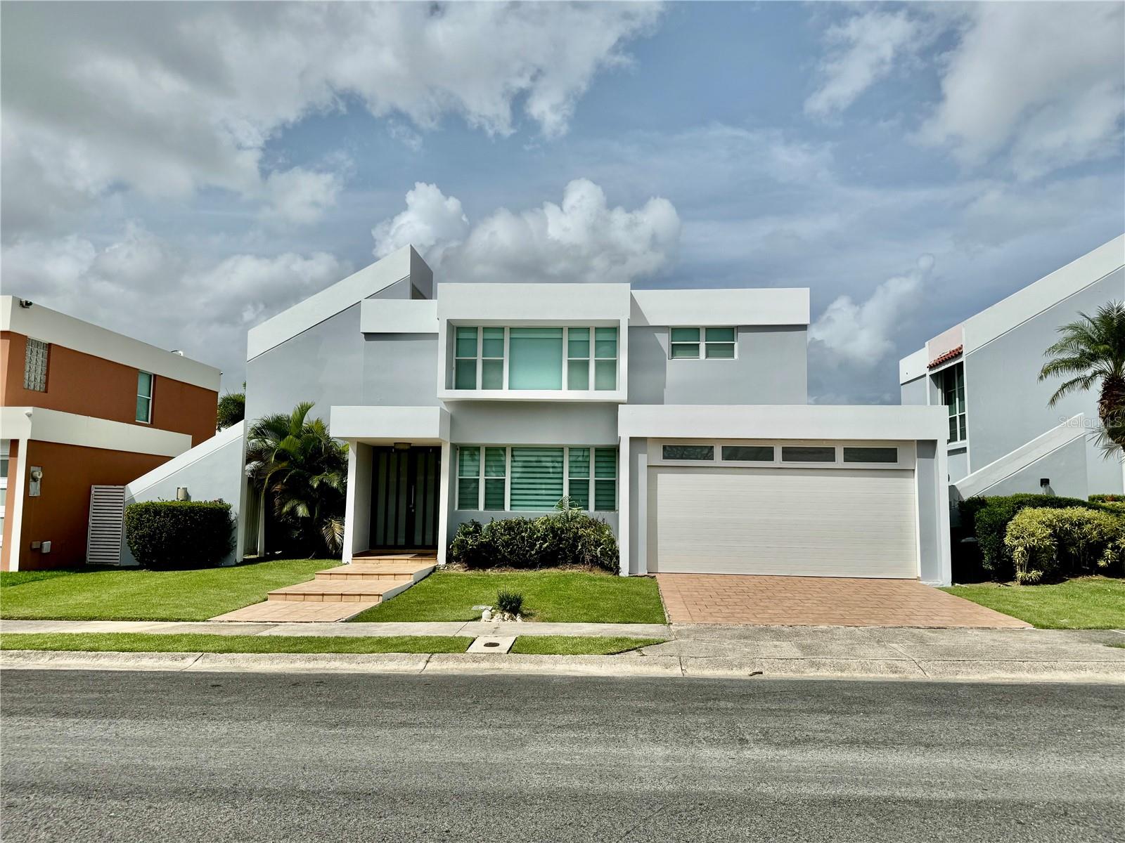 This four-bedroom, two-and-a-half-bathroom home is the perfect setup for comfortable living in the highly desirable Paseo Las Olas community in Dorado. Thoughtfully designed with space and functionality in mind, the home welcomes you with a bright entryway and an open-concept layout on the first floor that seamlessly connects the dining area, breakfast nook, kitchen, and main living room—ideal for everyday living and entertaining. A separate family room and an extended bonus area provide added flexibility, perfect for a home office, media room, or additional lounge. A conveniently located half bathroom completes the main level. Step outside to a covered terrace and patio—ideal for hosting guests or enjoying peaceful evenings outdoors. Upstairs, the home features four generously sized bedrooms, two full bathrooms, and a dedicated laundry room. The spacious primary suite includes dual walk-in closets and a well-appointed en-suite bathroom with double vanities, a soaking tub, and a separate walk-in shower. Natural light fills the interior, enhancing the home’s bright and airy atmosphere. Additional highlights include a double car garage, a solar panel system with battery backup, and a water cistern. Ideally located just steps from the community’s amenities—including a swimming pool, gazebo, basketball and tennis courts, and a playground—this home truly offers the perfect setup for comfort, convenience, and lifestyle.