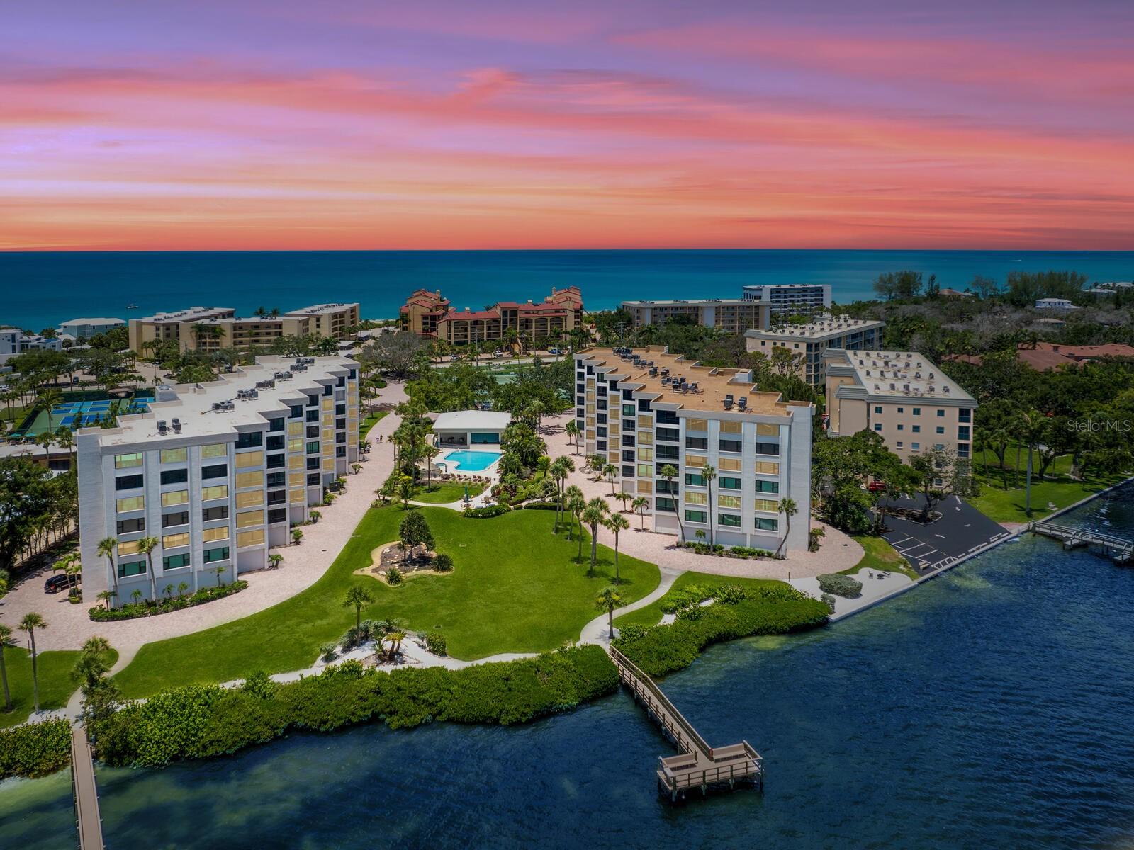 The best of bayfront living on Siesta Key with deeded beach access and boat slips. Experience the best of island living in this impeccably renovated bayfront residence at Turtle Bay, ideally on the serene southern end of world-renowned Siesta Key. Wake each morning to spectacular sunrises over the Intracoastal Waterway and wind down with vibrant sunsets near the beach—this is the quintessential Florida lifestyle. This spacious and stylish two-bedroom, two-bath condominium has been thoughtfully redesigned, including raised ceilings that enhance the open, airy feel. Throughout the home, you'll find designer tile flooring and elegant plantation shutters. The gourmet kitchen and both baths have been beautifully updated with crisp white wood cabinetry, stone countertops and sleek stainless steel appliances, creating a bright, modern coastal aesthetic. Enjoy gentle bay breezes from the screened terrace or relax in comfort indoors. A convenient full laundry room offers additional storage, and an oversized private one-car garage adds extra value and ease. Pet friendly, Turtle Bay offers an exceptional array of amenities, including beautifully landscaped bayfront grounds, deeded beach access directly across Midnight Pass Road, a heated pool and spa, tennis courts, boat slips (available on a first-come, first-served basis), and a charming picnic and grilling area. Minutes to the South Village, you'll enjoy effortless access via the free trolley to shopping, dining and entertainment, and a short ride to Siesta Village's unique shops and eateries. Nearby Point of Rocks is a favorite destination for snorkeling and fishing. Just minutes from Stickney Point Bridge and only 20 minutes to downtown Sarasota’s vibrant arts, culture and culinary scene, this condominium offers the best of Siesta Key living. Whether you're seeking a tranquil retreat or an active coastal lifestyle, this residence delivers it all.