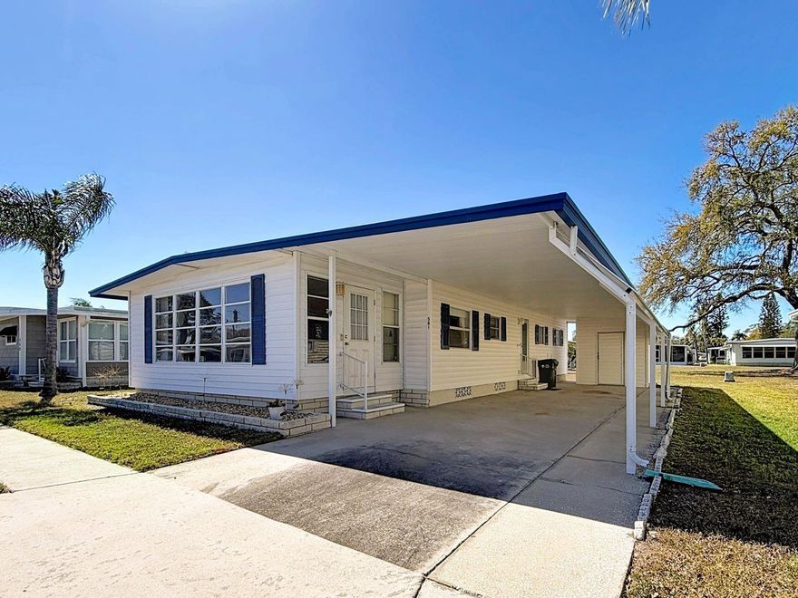 Live your Florida golf dream in Fairway Village, a stunning 55+ RESIDENT-OWNED community in Largo, Florida! This is NOT LOT RENT- you own a share of the park when you purchase a home here, and the share is included in the asking price! This home is located with green space behind it, making it feel more open! The home has a generous sized carport, and the attached storage shed is where you will find the washer and dryer. Inside the home, the kitchen has no shortage of cabinetry, and features eating space. The living room is also spacious, and the front Florida room spans the entire width of the home! The guest bedroom is a generous size, but the primary bedroom, complete with multiple closets and an ensuite bathroom, is a true show stopper- it's huge! The guest bathroom features a shower / tub combo and the primary bathroom has a walk-in shower. The home is being sold fully furnished, with the exception of a few items shown in the photos that belong to the current snowbirds. The community features a 9-hole golf course; 5 acre lake for catch and release fishing; two swimming pools with hot tubs; eight shuffleboard courts; a stunningly new (finished in 2022) 19,000+ square foot clubhouse with massive auditorium, stage, conference rooms, fitness center, library, billiard room, card room, and wifi. The 2026 monthly fee is $420 per month and includes water, sewer, in-home high sped internet access, 220+ Spectrum cable TV channels, curbside trash pickup, lawn pest control, and lawn care. You can also purchase a 2026 annual golf membership for $440 per year plus sales tax. Sorry, this home is NOT in the pet section (ESA is not a pet).