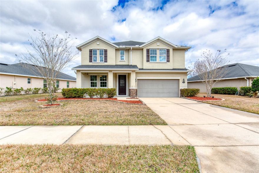 One or more photo(s) has been virtually staged. Beautiful, Waterfront 4 Bedroom 2.5 Bath 2 Car Garage with over 2800 SQ FT of living space in the sought-after Hunters Ridge community. The main level is designed for durability featuring luxury vinyl plank flooring that transitions from the entryway den into a spacious living area centered around a fireplace. The open kitchen is fully equipped with ample counter and storage space, granite countertops, center island with breakfast bar, upgraded cabinetry, dual pantries and stainless steel appliances. Enjoy tranquil views of the fountain on the lake from the living area, kitchen and eat-in dining space. Step out to the fully screen enclosed lanai to enjoy a well equipped summer kitchen. The second floor features all four bedrooms and plush carpeting. The expansive primary suite is large enough to accommodate a separate sitting area or office nook and includes architectural tray ceilings, walk-in closet with custom built-ins, double sink vanity, walk-in shower, and Jacuzzi soaking tub. Enjoy two spacious bedrooms with access to the guest bathroom featuring a double sink vanity and walk-in shower. The oversized fourth bedroom is the ultimate flex space and could easily function as a play room, work out room, or office. Recent upgrades include a 2023 A/C and fresh interior paint . For additional piece of mind, the property is fully equipped with corrugated hurricane shutters. The community of Hunters Ridge offers extensive amenities including two swimming pools, a clubhouse, tennis and pickleball courts, a fishing dock, and a canoe launch. Square footage per tax rolls. All information intended to be accurate but not guaranteed.