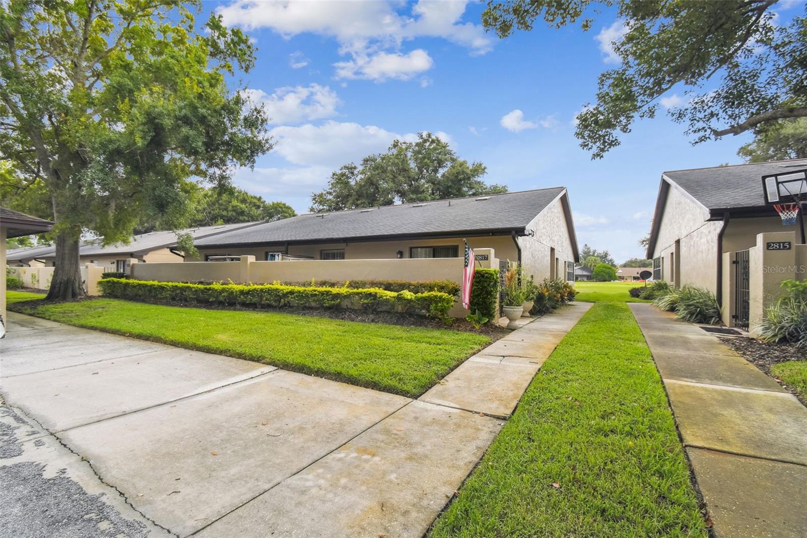 Welcome to 2817 Wingfoot Ct, located in the desirable Cypresswood Golf Villas. This beautifully maintained villa sits along the 8th fairway of the prestigious Cypresswood Golf & Country Club, a guard-gated community offering both privacy and tranquility. Inside, you'll find three spacious bedrooms and two full bathrooms. The living and dining areas feature vaulted ceilings that enhance the open and airy atmosphere. The eat-in kitchen is a standout with new custom cabinetry, granite countertops, and a convenient closet pantry. Flooring throughout the home includes durable laminate and ceramic tile, with cozy carpeting in the third bedroom. The primary suite offers sliding doors to the patio, a generous walk-in closet, and an updated bathroom. The secondary bedroom also includes a walk-in closet, while the third bedroom features patio access and a European-style A/C unit. Major updates include a roof replacement in 2022, and a new A/C system installed in 2019. Covered parking adds convenience. Enjoy resort-style living with scenic golf course views and access to community amenities, all just minutes from shopping, dining, and major roadways. Whether you're seeking a year-round residence or a seasonal escape, this villa is the perfect place to call home. Community pool, tennis, clubhouse & restaurant.