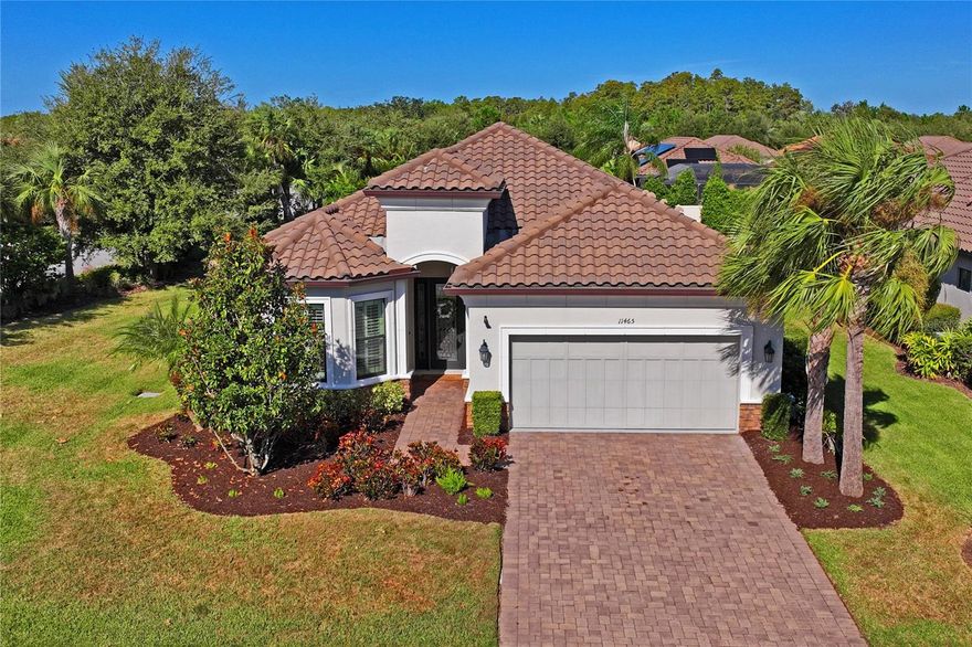 This beautiful house is worthy of being featured in a Southern Living magazine and ready to become your home. This pristine kept, lovingly maintained, and beautifully designed Taylor Morrison LAZIO on a corner lot, provides the perfect blend of comfort, elegance, and Southern Charm. With 3 BEDROOMS, 3 BATHROOMS, a versatile DEN/OFFICE SPACE, and spacious 2-car garage, this home is a standout in both design and livability. The open-concept layout is accentuated by ENGINEERED WOOD FLOORING and NEUTRAL TONES THROUGHOUT. The GOURMET KITCHEN has GRANITE COUNTER-TOPS, VEGGIE SINK, CAFE HIGH-END GAS APPLIANCES (with the OPTION for ELECTRIC), AMPLE CABINET SPACE, and a spacious 10 ft. KITCHEN ISLAND with KNEE WALL CABINETS for additional kitchen storage. Adjacently, the living room and dining space along with the COVERED, SCREEN-ENCLOSED LANAI, make for an ideal spacious and seamless entertaining when hosting your guests. The Lanai is decorated with STUNNING HURRICANE IMPACT FRENCH DOORS in both Living room and Kitchen entry from the outdoors. The OWNER'S PRIMARY SUITE is LUXURIOUS with BAY WINDOW, TRAY CEILING, EN-SUITE BATH with 10 ft. WIDE WALK-IN SHOWER, and an EXPANSIVE WALK-IN CLOSET with CUSTOM BUILT-INS. A PRIVATE JUNIOR SUITE provides comfort for guests or multi-generational living. The additional bedroom and full bath are ideally situated for maximum privacy and convenience. A beautifully FINISHED LAUNDRY ROOM adds both function and style which include your durable CABINETRY FOR STORAGE, WASHER, DRYER, a DROP ZONE COUNTER SPACE, and UTILITY SINK. Enjoy the Florida lifestyle year-round from your COVERED LANAI, with a PRIVATE VIEW of your backyard surrounded by LUSH, TROPICAL Florida native LANDSCAPE. Entertain with ease using your NATURAL GAS OUTDOOR KITCHEN, complete with sink—perfect for weekend gatherings and sunset dinners. The home is equipped with 8 FT DOORS, 10 FT CEILINGS, CROWN MOLDING, TRAY CEILINGS, PLANTATION SHUTTERS in FRONT BAY WINDOW, HURRICANE SHUTTERS, TANKLESS WATER HEATER, STORAGE SHELVING IN GARAGE, SECURITY SYSTEM, and a WHOLE-HOME WATER SOFTENER. The TILE ROOF and PAVER DRIVEWAY not only adds to the home’s curb appeal, but also long-term durability. This home also comes with a REDUCED CDD FEE as the current owner PAID OFF THE SERVICE FEE giving a $1,300 reduction making it $2,200 a year. As an Esplanade resident, your HOA dues COVER ALL COMMUNITY AMENITIES, including clubhouse access, FITNESS/GYM CENTER, walking trails, HEATED POOLS AND SPA, FIREPIT, PICKLEBALL, TENNIS, and SHUFFLEBOARD COURTS, on-site manager, planned year-round community events, and so much more—along with COMPREHENSIVE LAWN MAINTENANCE, ensuring low-maintenance living. Plus, enjoy full access to all Starkey Ranch amenities including parks, pools, community garden, and recreational facilities. This home combines refined design with everyday practicality—ideal for those who appreciate thoughtful upgrades, modern convenience, and a vibrant, amenity-rich neighborhood. The community is strategically located near major highways for swift commutes, shops, hospitals, local favorites, Famous Beaches, and much more. Whether you're looking to relax in style or entertain in elegance, this charmer delivers on every level. Don’t miss the opportunity to own one of Taylor Morrison’s most beloved floor plans in one of the most desirable communities in the area. Schedule your private showing today and experience firsthand the exceptional lifestyle that awaits!