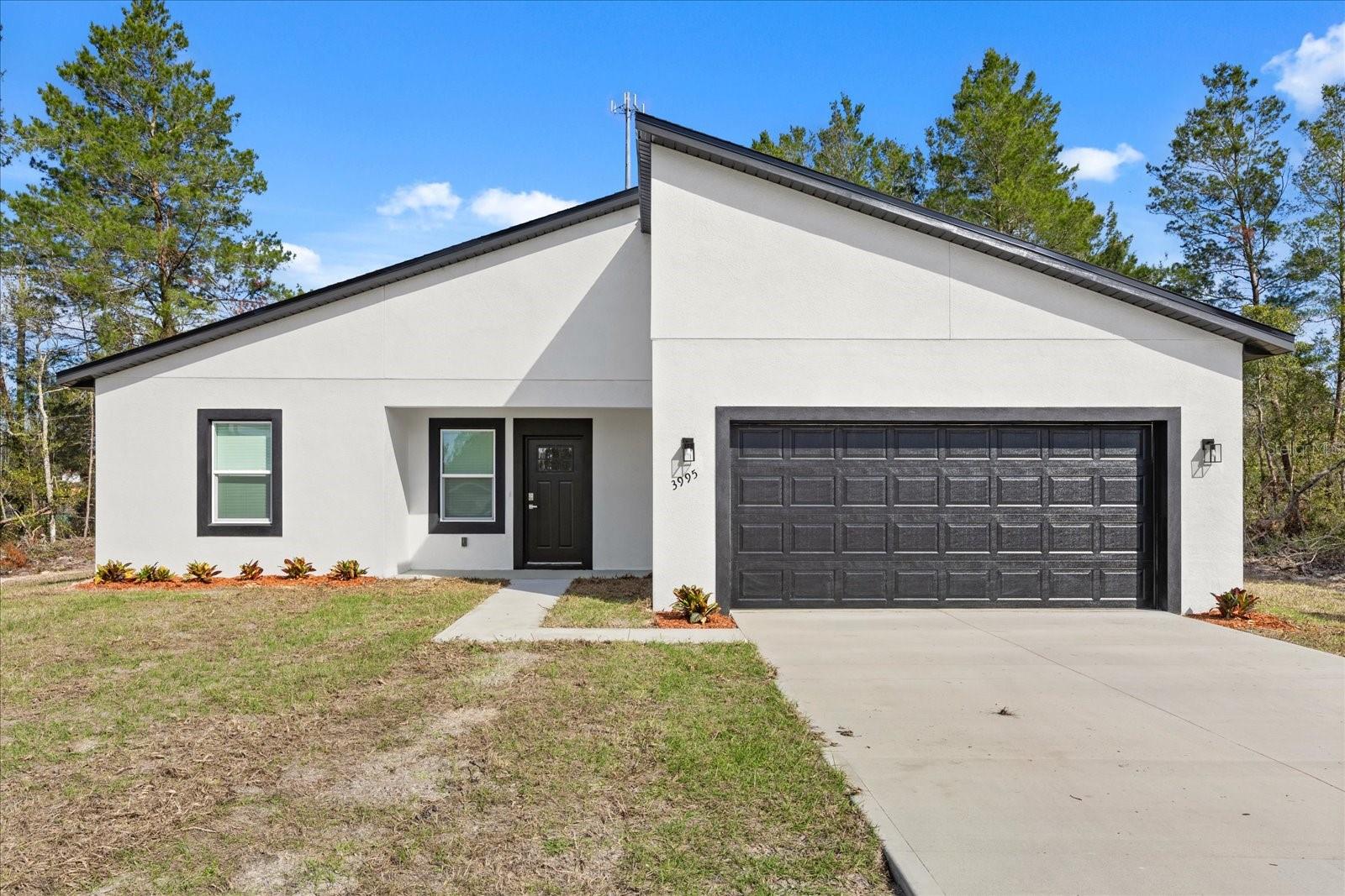 Space, style and a location you'll love at a great price point! Be the first to occupy this new 4/2 with 2-car garage, located on a circle in a quiet neighborhood. As you enter, you will notice that the high ceilings throughout lend to the open feel of the home. The kitchen offers generous lighting, granite counters, upgraded SS appliances and a pantry closet. There is luxury vinyl plank flooring throughout the home, except for the Primary Bathroom. The Primary Bath offers everything you could ask for: Separate room for water closet, a shower, separate soaking tub, higher double vanity with stone counter and lots of space. There are window treatments throughout the home as well. You will love the location of this home in Marion Oaks Unit 2. It is just four miles from I-75 and less than two miles to the new Aldi’s, only five minutes away! Marion County’s newest high school is under construction in Marion Oaks, just four miles away. All of this, and it is under a 1-year full Builder’s Warranty. Come see this beautiful home in a growing area. You will want to make it yours!