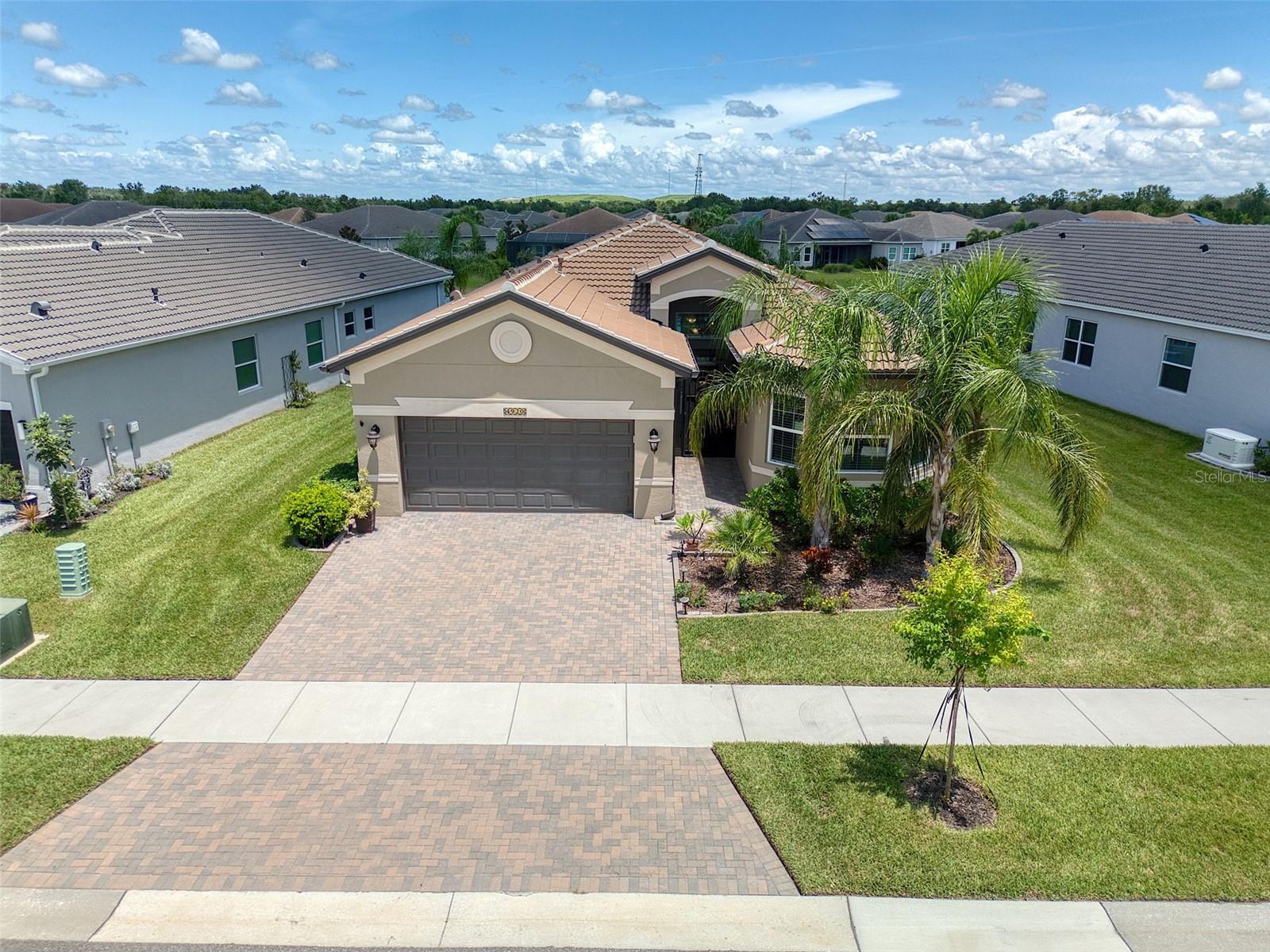 DREAM HOME in 55+ Resort Community. Better than New Construction! Recently Built + Tons of HIGH-END UPGRADES. $35,000 in Hurricane/Impact Windows & Sliding Doors! This model has 3 OVERSIZED BEDROOMS. HUGE LUXURY KITCHEN with Quartz Countertops; High-End Wood Cabinets w/ Soft-Close Drawers; Premium Matching Stainless Steel Appliances, including GAS RANGE; & Recessed Lights. Large Breakfast Bar, Dinette/Breakfast Nook, plus Dining Room. SPECTACULAR GREAT ROOM with truly extraordinary set of 8 Glass Sliding Doors + Roller Shades controlled by remote! ; Recessed Lights; & High-End Oversized Ceiling Fan. LUXURIOUS DOUBLE-SIZE MASTER SUITE w/ His & Hers Closets; Built-In Closet System; ENORMOUS ENSUITE BATHROOM w/ Dual Vanities; Round Kohler Sinks; Large Walk-In Shower w/Bench; Built-In Makeup Desk; Granite; High-End Wood Cabinets; & Soft-Close Drawers. SPECTACULAR WATER VIEW BEHIND HOME - no rear neighbors. HUGE COVERED SCREENED REAR PORCH/LANAI was EXTENDED; also Screened FRONT PORCH/LANAI was added. The Sliding Doors in Great Room surprisingly open up to unite the Great Room + Rear Porch, PERFECT FOR PARTIES & HOLIDAYS. Surround Sound Ceiling Speakers in both Great Room & Rear Porch. SPLIT BEDROOM. Front Bedroom w/ 3 Large Windows, could easily be converted to a Mother-In-Law Suite by adding a door. LARGE LAUNDRY ROOM w/ Utility Sink, Built-In Desk, Washer, & GAS Dryer. (Gas dryers have faster drying times & lower operating costs). 3-CAR GARAGE W/ Epoxy Floor; 2nd Refrigerator, & Many Extra-Large Built-In Shelves. EXTRA EXTERIOR FEATURES: Home is BLOCK (protection from hurricanes), and $35,000 Impact Windows & Doors (protection from hurricanes & sound). TILE ROOF (much longer lifespan than shingle roof). GENERATOR in garage provides full power during a power outage. Basketweave Pavers in driveway and both porches. Water Softener. Water Heater w/ Circulation. Bigger Size AC. Palm Trees. Exterior Stucco Finish. Exterior Rear Gas Connection (ready for BBQ/Kitchen). Fishing at pond behind home! EXTRA INTERIOR FEATURES: Tray Ceiling in Great Room, Master Bedroom, & Entrance; High 10' Ceilings; Plenty of Extra Closets/Storage; Premium Interior Doors; Premium Faux-Wood Norman Blinds. VALENCIA DEL SOL is an Exclusive, Gated, LIFESTYLE COMMUNITY. Full-time Lifestyle Director coordinates Clubs, Classes, Card Games, Arts & Crafts, Karaoke, Water Aerobics, & Yoga. There are also opportunities to attend Shows, Concerts, & Dances! Valencia del Sol has its own Resort-Style Pool, Restaurant & Bar ("Bistro del Sol"), 25,000 square foot Clubhouse, Fitness Center (includes fitness classes), Racquetball, Tennis Courts, & Dog Park. HOA Fee Includes A LOT with No CDD expense: Resort-Style Living; Lawn service, maintenance, & irrigation; 24-Hour Guard & Security; Trash, Water, & Sewer. No Flood Zone. Community is located right off of US-301, with Walmart, Publix, & Starbucks nearby. Easy Access to Tampa, Sarasota, & St Petersburg. Great Hospitals Nearby. Easy access to Airports & Beaches. ** Note that furniture is optional.