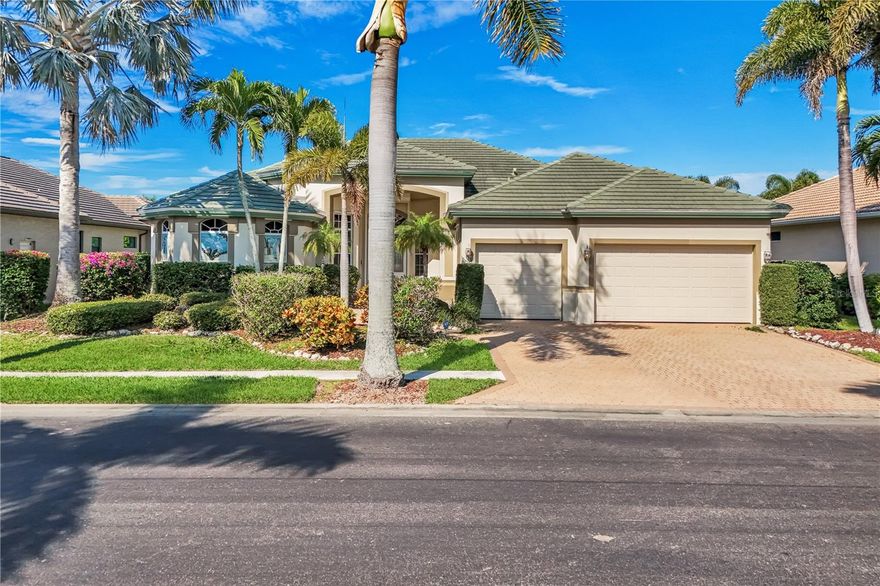 Located in the exclusive gated boating community of Catalpa Cove, this waterfront home WITH NEARLY 2600 SQ. FT. offers rare direct canal access to the river. Ideally situated just 5 minutes to Sanibel Island, 10 minutes to Fort Myers Beach, and approximately 20 minutes to Southwest Florida International Airport. Featuring 3 bedrooms + den and 3 full baths, the home includes double leaded glass entry doors opening to a bright floor plan with immediate views of the private pool and lanai. The kitchen offers solid wood cabinetry, granite counters, ample counter space, pantry, breakfast bar, and breakfast nook overlooking the outdoor living area. The great room features custom built-ins with accent lighting and flows into a spacious dining area. The primary suite includes dual vanities, a jetted tub, walk-through shower, and decorative stained glass windows. Bamboo flooring in bedrooms; polished travertine throughout main living areas. Outdoor features include a heated pool and spa, brick paver deck, covered seating area, and outdoor kitchen space with privacy hedging. Property includes use of dock and lift behind house. Recent updates: new garage doors on the 3 car, 727 sq. ft. garage, new TILE roof, new A/C, resurfaced pool. Community amenities include GAZEBO AREA WITH tennis/pickleball courts.