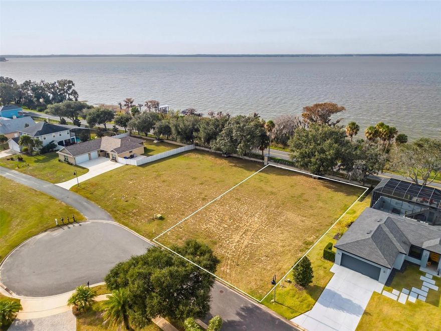 Rare Opportunity to Build on the Harris Chain of Lakes with Included Lakefront Parcel! Now is your chance to create the custom home you’ve been dreaming of while enjoying direct access to Lake Eustis and the Harris Chain of Lakes. This unique offering includes a .52-acre homesite within the gated community of Etowah, plus the lakefront property located directly across Lake Shore, giving you 100 feet of true waterfront ownership. The included lakefront parcel provides the perfect location to build your private boathouse, offering immediate access to boating, fishing, water skiing, and endless exploration throughout the Harris Chain of Lakes—an interconnected system of renowned freshwater lakes known for exceptional recreation and waterfront living. Imagine spending your days on the water and your evenings enjoying breathtaking Lake Eustis sunsets from your future home. Conveniently located near AdventHealth Waterman Hospital and just minutes from shopping, dining, and waterfront entertainment in Tavares, this location offers both tranquility and accessibility. Residents of Etowah enjoy resort-style amenities, including a pool, playground, sidewalks, tennis courts, and basketball court—all included in the HOA.
Opportunities that combine a buildable homesite with separate, deeded lakefront access on the Chain of Lakes are exceptionally rare. Bring your builder, envision your lifestyle, and experience the freedom of true lake living. Schedule your private showing today and secure your place on the water.