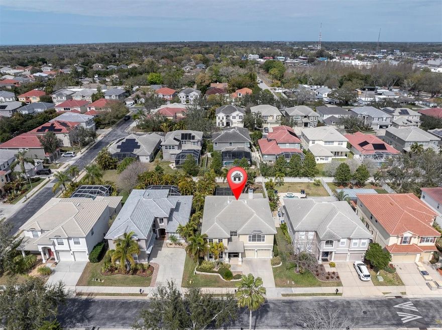 One or more photo(s) has been virtually staged. Welcome home to Highland Woods. One of the best places to live in Pinellas County, minutes to to Honeymoon Island, shopping and entertainment. This 4 bedroom, 3.5 bath home with your own tropical oasis is waiting for you! As you enter the home you will notice the gorgeous hand scraped hardwood flooring in the living room, dining room, family room, office & master bedroom. The well-appointed kitchen features granite counter tops and tons of storage in the cabinets plus a temperature controlled wine cellar. Large bedrooms throughout with the primary bedroom on the first floor with a great en-suite bath and walk in closet. The great room overlooks the lanai and has a real wood burning fireplace. The refreshing oasis style pool with spa and waterfall will be terrific for holding your summer bbq's and the home has a pool bath located right off the lanai. Upstairs features a huge bonus room 3 bedrooms, a loft  & 2 full bathrooms. There is plenty of storage & the tandem garage has room for 2 cars plus all your sports equipment. One of the largest fenced in backyards in the community allows the family & pets to play safely. This terrific gated community has low hoa fees & does not need flood insurance. This immaculate home is priced to sell quickly so don't delay schedule an appointment to see this beauty today.