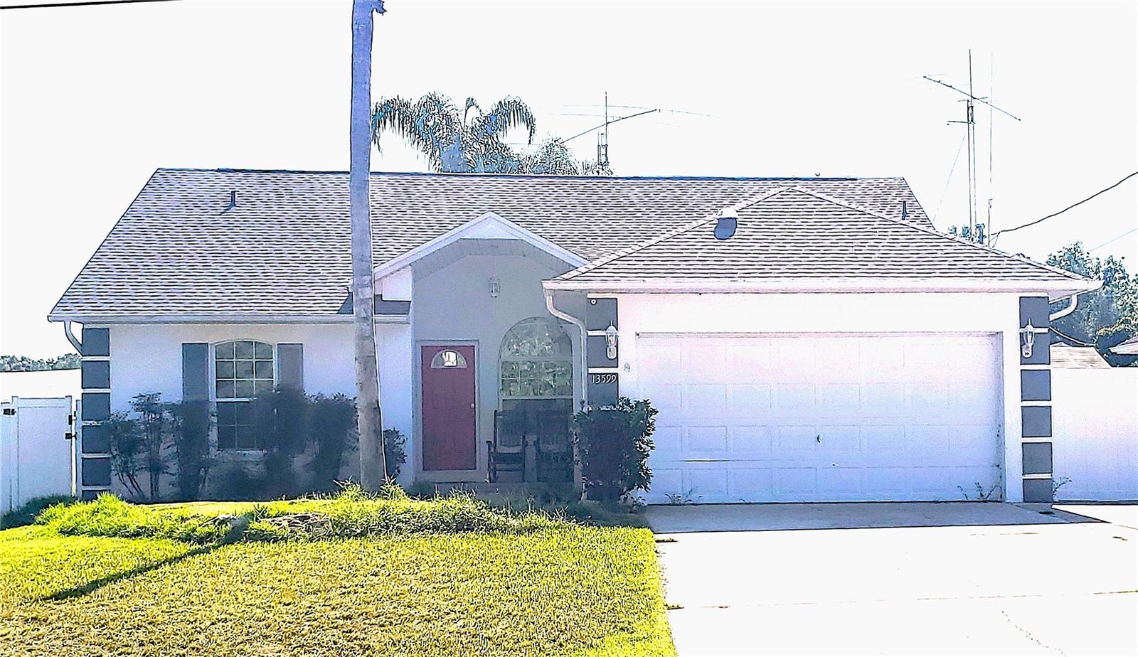 This beautifully crafted concrete and stucco home built in 2002 offers a 3-bedroom split floor plan, 2 bath with a converted bonus bedroom and an additional flex room to customize to your family's needs. This home boasts vaulted ceilings accented with gleaming hardwood floors in the living, dining and bedrooms. The dining room features bay windows and a farmhouse-style chandelier. The kitchen is updated with SS appliances, tiled floors, and a large pantry closet. Step into a huge laundry area off of the kitchen that gives extra space as the garage has been converted into the 4th bedroom with a solar tube and a laundry area with its own entrance that includes a folding counter, shelves and convenient laundry sink. Both areas can be easily transitioned back into a garage. The spacious master suite includes vaulted ceilings, his & her closets, and a bath with walk-in shower. HVAC 2020, New ROOF 2022, no HOA/CDD fees. Close to Ocala, Belleview and The Villages. Schedule your private showing today and take advantage of this amazing home.