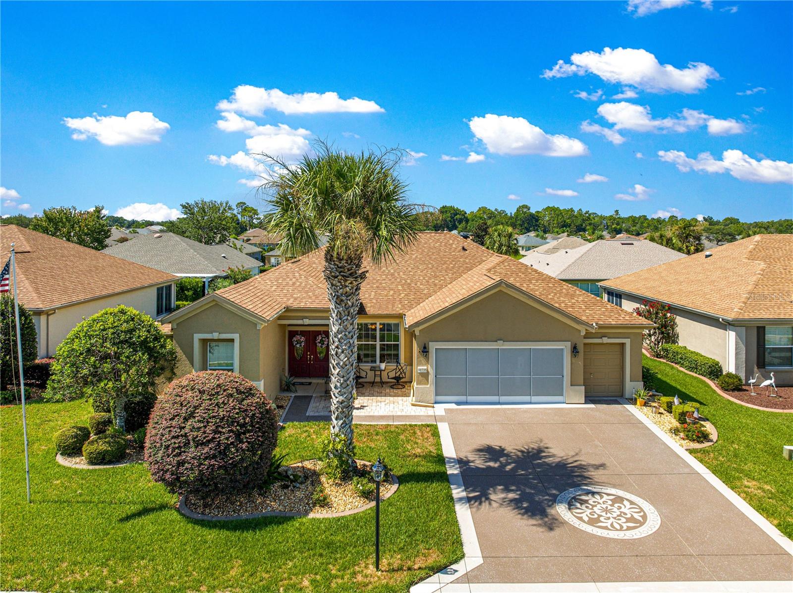 Welcome to this beautifully updated and maintained 3-bedroom 2 bath Kingston floor plan, offering 2,413 sq ft of heated and cooled living space in the highly sought after Del Webb Spruce Creek Golf & Country Club. Built in 2005 with concrete block and stucco construction, this home impresses from the start with outstanding curb appeal-a custom painted driveway, double garage with sliding screen door, and a separate golf cart garage, front brick paver patio, and elegant double leaded glass entry doors. Inside, you’ll find a large open area with a foyer, formal living and dining room, detailed with crown molding and newer 18-inch tile flooring throughout the main living areas, windows are adorned with wood cornices. The split floor plan offers ideal privacy. The spacious primary suite features sliding glass doors with direct access to the Lanai, a huge walk-in closet, and a luxurious en-suite bath with soaker tub, frameless glass double shower, raised sinks, and raised toilet, with dual vanities and ample storage. The modernized kitchen is an entertainers dream, showcasing granite countertops, tile back splash, upgraded solid wood cabinetry, black stainless-steel appliances, and a solar tube for natural light, while the breakfast bar overlooks both the nook and light-filled great room. The guest wing features two comfortable sized bedrooms and a full guest bath. Enjoy Florida’s beautiful weather year-round from the screened Lanai or relax or grill on the open rear brick paver patio. The home is beautifully landscaped with concrete curbing and includes underground dog fencing. Additional recent updates include roof re-shingled in 2022; HVAC 2020 and the home has been re-piped as a preventative measure in walls and ceiling. This home is truly move in read, seller has priced home for a quick sale!